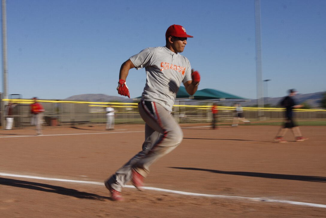 Ricky Galen, an all-star with the White team, rushes down the first base line June 30 at the Combat Center's Felix Field during the Commanding General's Intramural Softball League All-Star game. Galen and other players were chosen from around the league to represent their teams in the games.