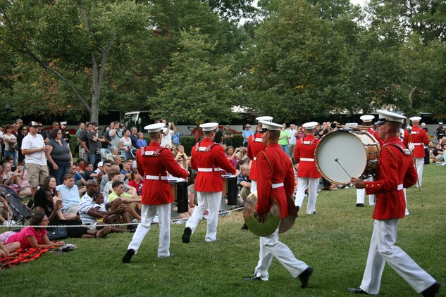 The Commandant’s own U.S. Drum and Bugle Corps passes in review in front of Marine Tactical Electronic Warfare Squadron 4 Marines and their family members at the Sunset Parade in Arlington, Va., June 29. VMAQ-4 also stopped in Quantico, Va., to visit the National Museum of the Marine Corps.::r::::n::::r::::n::