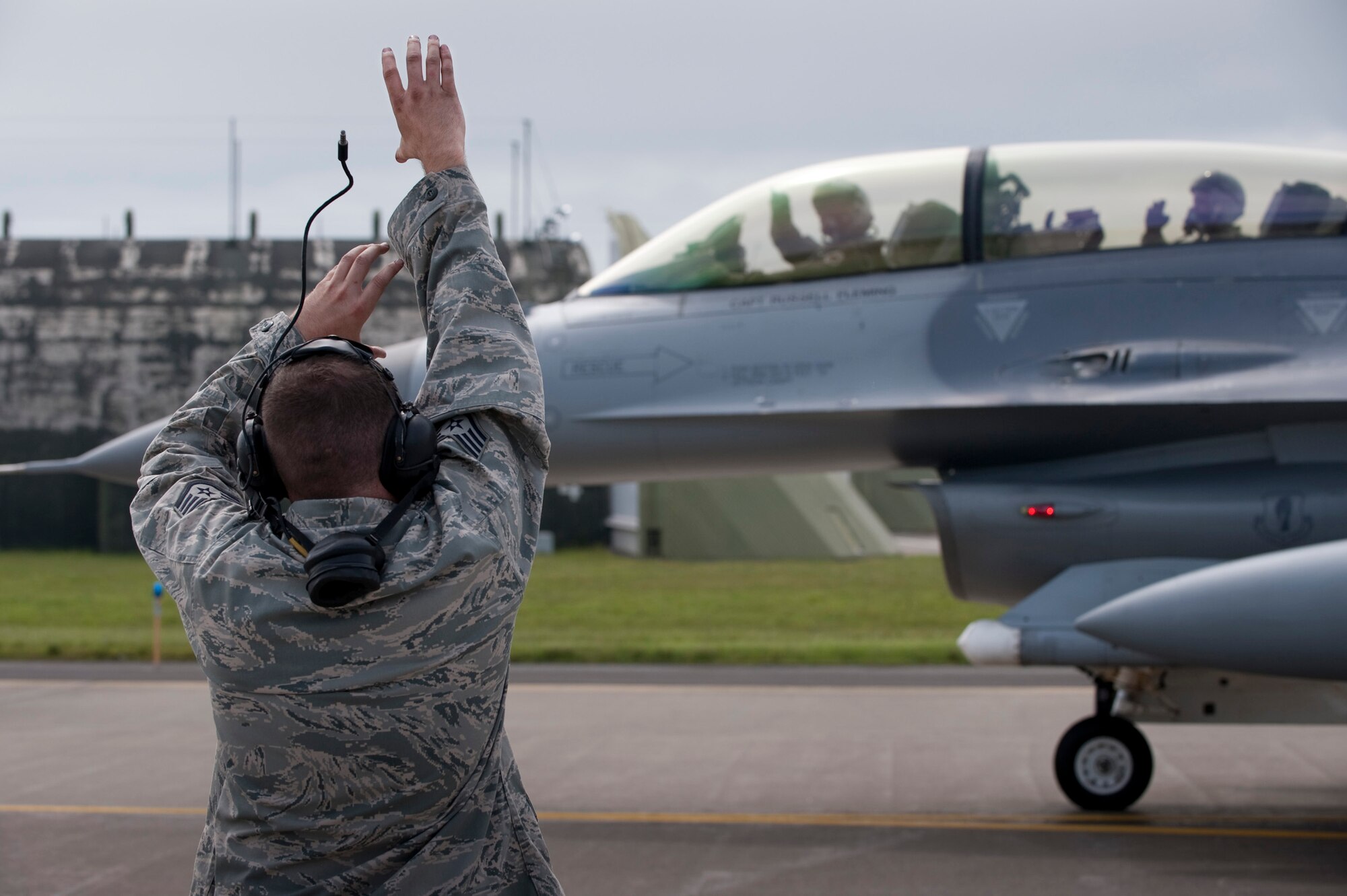 MISAWA AIR BASE, Japan -- Staff Sgt. Sean Moore, 13th Aircraft Maintenance Unit crewchief, gives a panther salute to Lt. Gen. Edward Rice Jr., U.S. Forces Japan and 5th Air Force commander, and Maj. Jordan Carvell, 35th Operations Support Squadron pilot, on the flightline June 28. (U.S. Air Force photo/Staff Sgt. Samuel Morse)