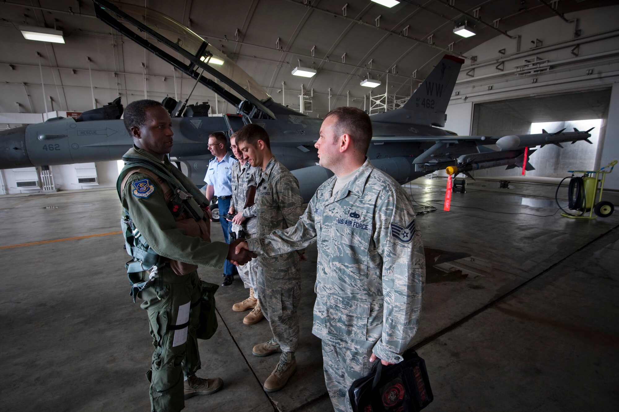 MISAWA AIR BASE, Japan -- Lt. Gen. Edward Rice Jr., U.S. Forces Japan and 5th Air Force commander, shakes hands with Staff Sgt. Sean Moore, 13th Aircraft Maintenance Unit crewchief, prior to a familiarization flight June 28. (U.S. Air Force photo/Staff Sgt. Samuel Morse)
