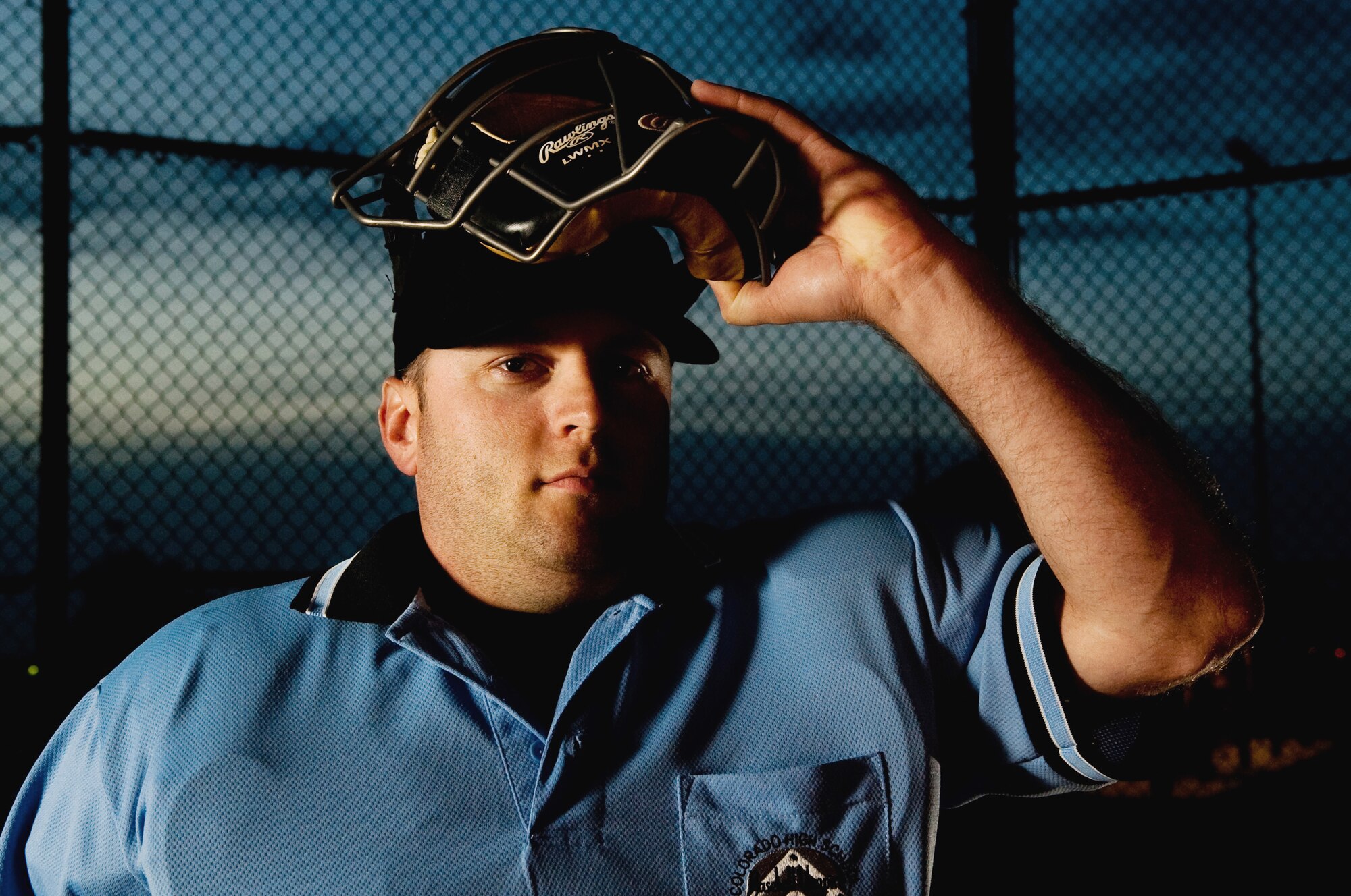 BUCKLEY AIR FORCE BASE, Colo. --  Staff Sgt. Larry Bouchard, Air Force Intelligence, Surveillance, and Reconnaissance Agency Detachment 45 Satellite Operations non-commissioned officer-in-charge, lifts up his face mask for a photo May 9. "A friend of mine was an umpire and knew I liked baseball," says Bouchard. "I tried it out and liked it so much that I continued with it." (U.S. Air Force photo by Staff Sgt. Kathrine McDowell)
