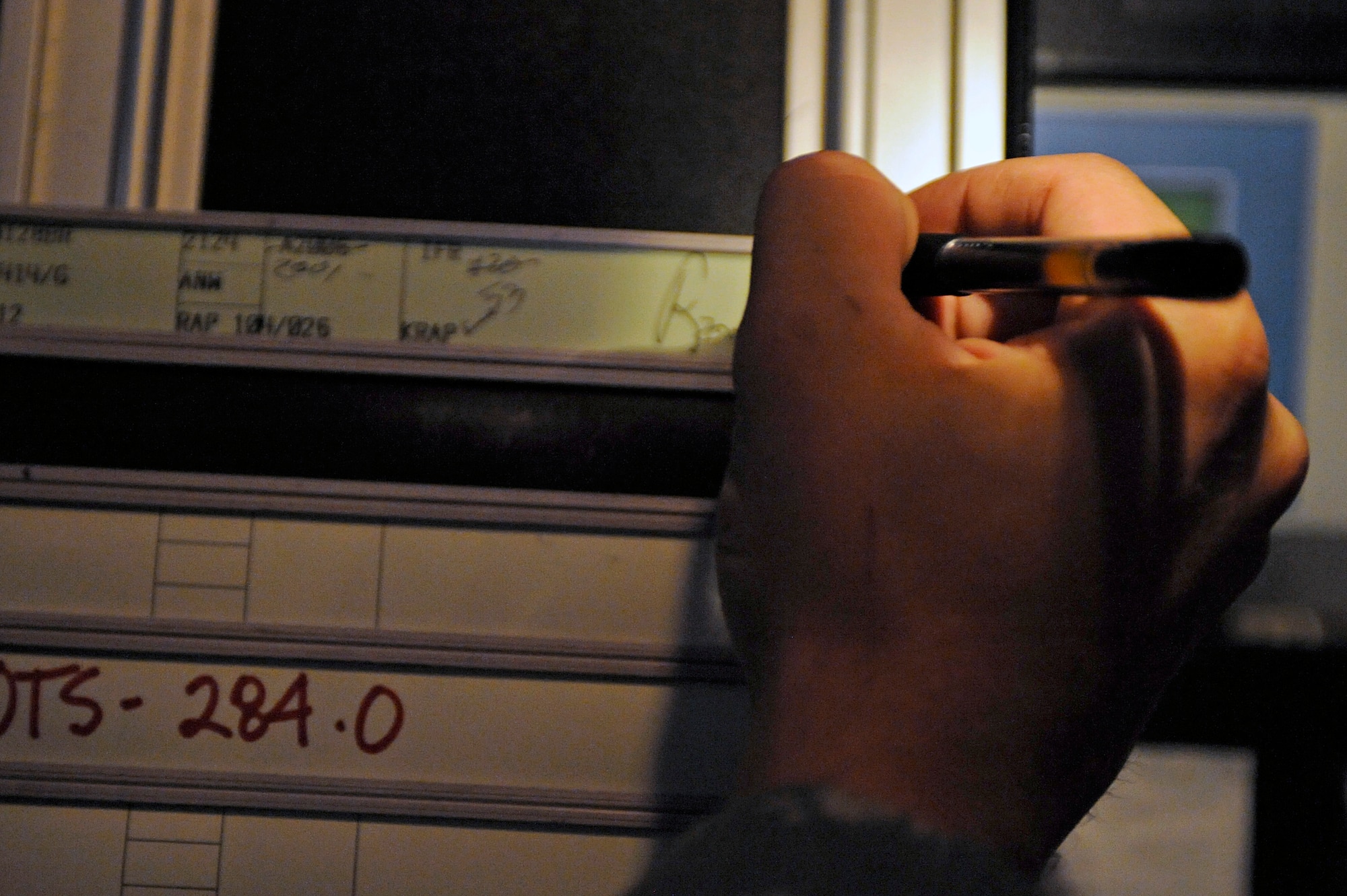 ELLSWORTH AIR FORCE BASE, S.D. -- Senior Airman Luke Miller, 28th Operations Support Squadron, marks a flight progress strip, June 29. Ellsworth air traffic controllers manage air traffic for Ellsworth Rapid City, Regional Airport, Minot Air Force Base and Minot International Airport. (U.S. Air Force photo/Airman 1st Class Matthew Flynn)