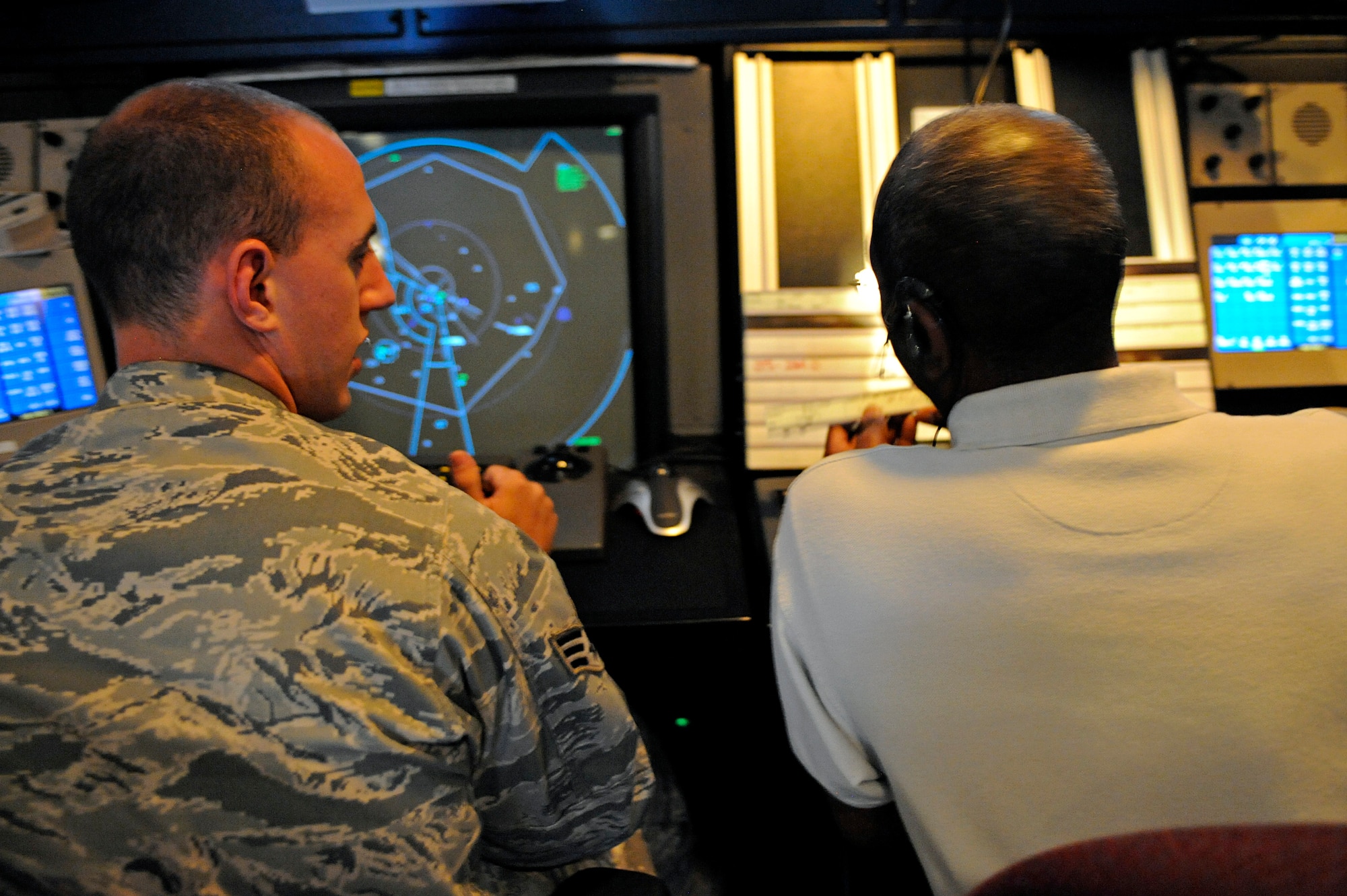 ELLSWORTH AIR FORCE BASE, S.D. -- (Left) Senior Airman Luke Miller and Henry Murchison, 28th Operations Support Squadron air traffic controllers, read a flight progress strip, June 29. The flight progress strip provides information such as the aircraft number and call sign. (U.S. Air Force photo/Airman 1st Class Matthew Flynn)