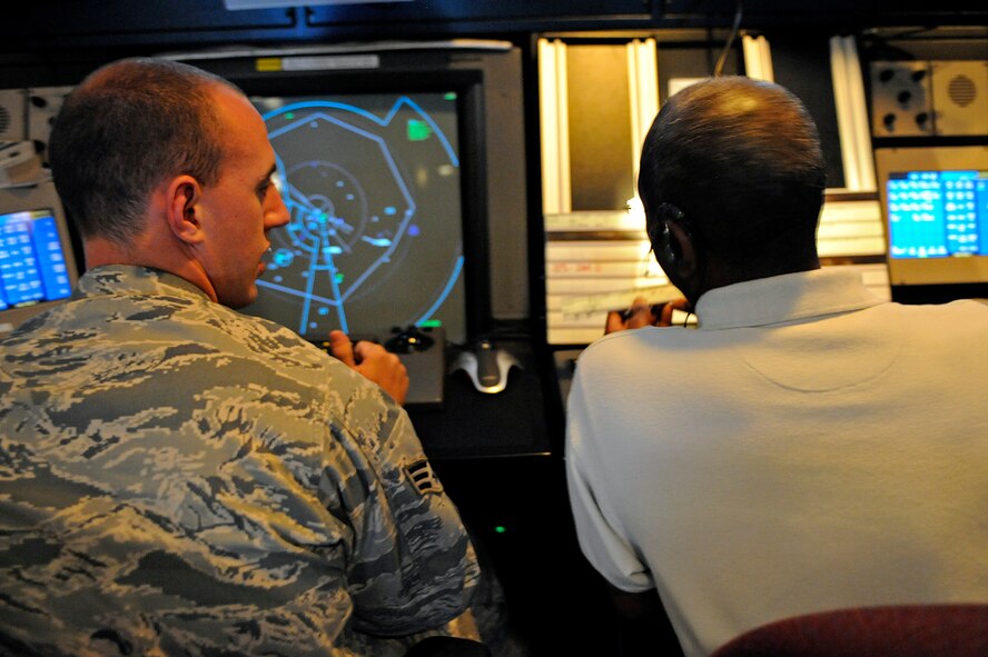 ELLSWORTH AIR FORCE BASE, S.D. -- (Left) Senior Airman Luke Miller and Henry Murchison, 28th Operations Support Squadron air traffic controllers, read a flight progress strip, June 29. The flight progress strip provides information such as the aircraft number and call sign. (U.S. Air Force photo/Airman 1st Class Matthew Flynn)