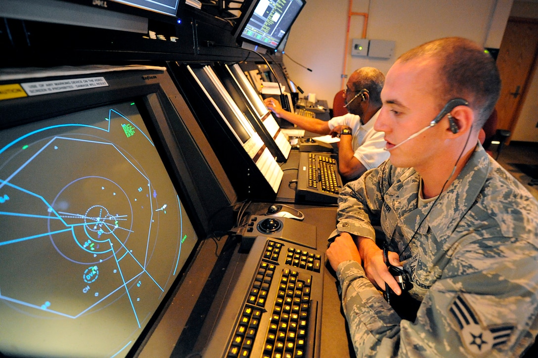 ELLSWORTH AIR FORCE BASE, S.D. -- (Front) Senior Airman Luke Miller and Henry Murchison, 28th Operations Support Squadron air traffic controllers, read radar scopes and communicate with pilots flying through the air space, June 29. Radar scopes allow air traffic controllers to view aircraft and local weather conditions. (U.S. Air Force photo/Airman 1st Class Matthew Flynn)