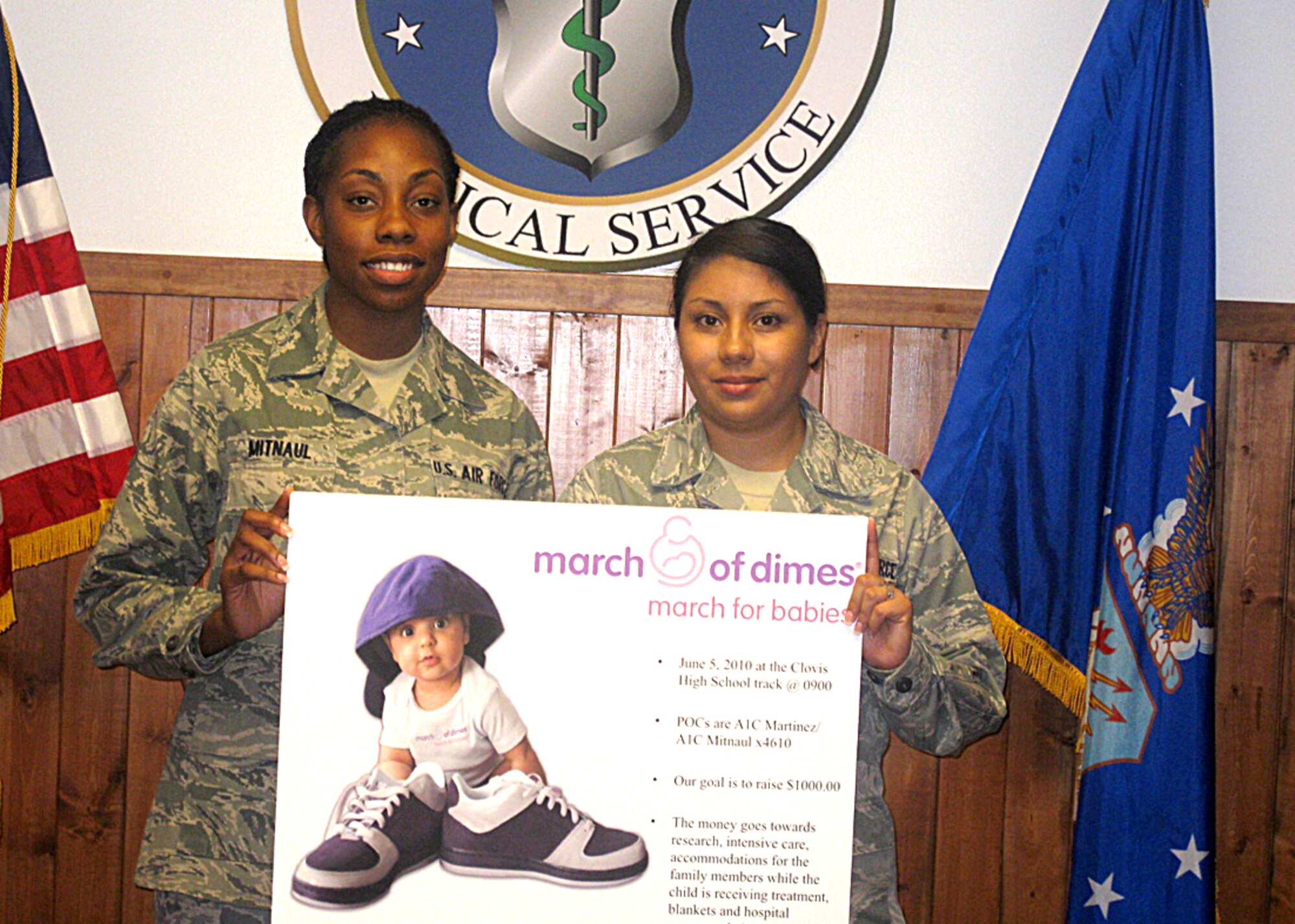 U.S. Air Force Airman 1st Class Senaah Mitnaul (left), and U.S. Air Force Airman 1st Class Nichole Martinez, 27th Special Operations Medical Support Squadron, display a poster for the March of Dimes March for Babies drive the 27th Special Operations Medical Group participated in June 5, 2010. The group raised more than $1,000 that will go toward research, intensive care treatment, blankets, and assistance for family members during their children's treatments. (Courtesy photo)