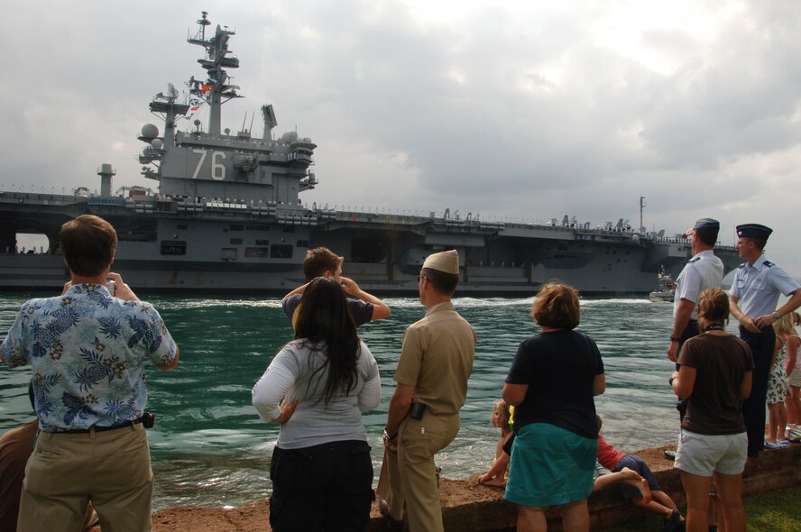 Spectators watch in awe as they welcome the USS Reagan, a U.S. Navy aircraft carrier, as it approaches Joint Base Pearl Harbor Hickam, Hi. June 29 to participate in the 2010 "Rim of the Pacific" exercise. RIMPAC is the world's largest maritime exercise held biennially in June and July in Honolulu, Hawaii under the leadership of United States Pacific Command. (U.S. Air Force photo by Staff Sgt. Nathan Allen)