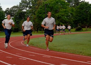 Airmen from the 437th Aircraft Maintenance Squadron run during their group physical training at 7:00 a.m. at the base track June 29, 2010 on Joint Base Charleston, S.C. New PT standards take affect July 1, 2010 and all Airmen will need a composite score of 75. Results will fall into one of three catagories: 90 and above, excellent; 75-90, satisfactory; and under 75, unsatisfactory. (U.S. Air Force photo/Senior Airman Timothy Taylor)