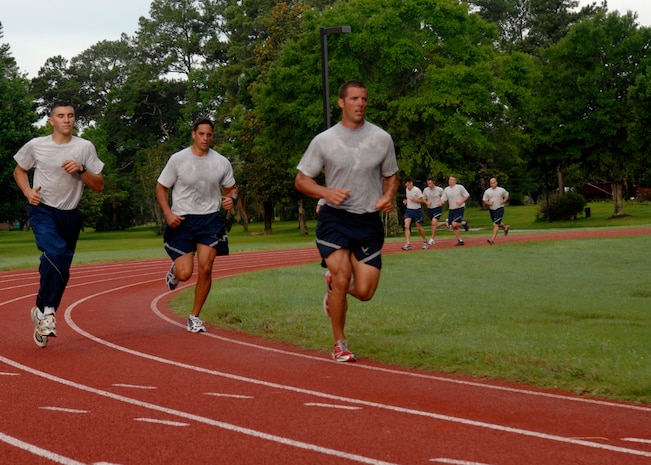 Airmen from the 437th Aircraft Maintenance Squadron run during their group physical training at 7:00 a.m. at the base track June 29, 2010 on Joint Base Charleston, S.C. New PT standards take affect July 1, 2010 and all Airmen will need a composite score of 75. Results will fall into one of three catagories: 90 and above, excellent; 75-90, satisfactory; and under 75, unsatisfactory. (U.S. Air Force photo/Senior Airman Timothy Taylor)