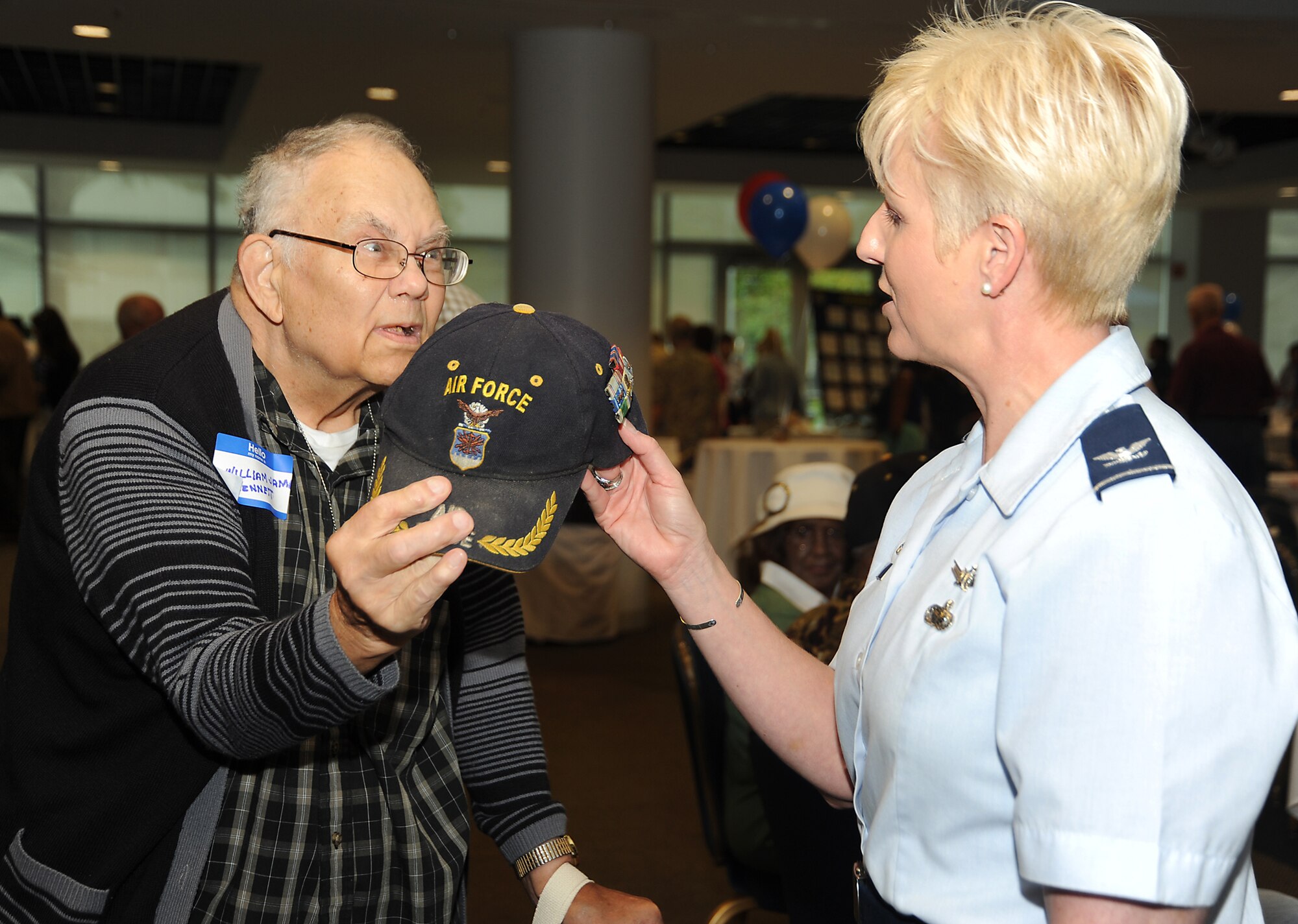 Retiree William Bennett shows his service ribbons to Col. Anita Latin, 61st Air Base Wing commander, at the annual Retiree Expo, June 26.  The expo was held in the Gordon Conference Center and featured speakers and information booths where retirees could learn more about programs, services and benefits available to them.   (Photo by Joe Juarez)