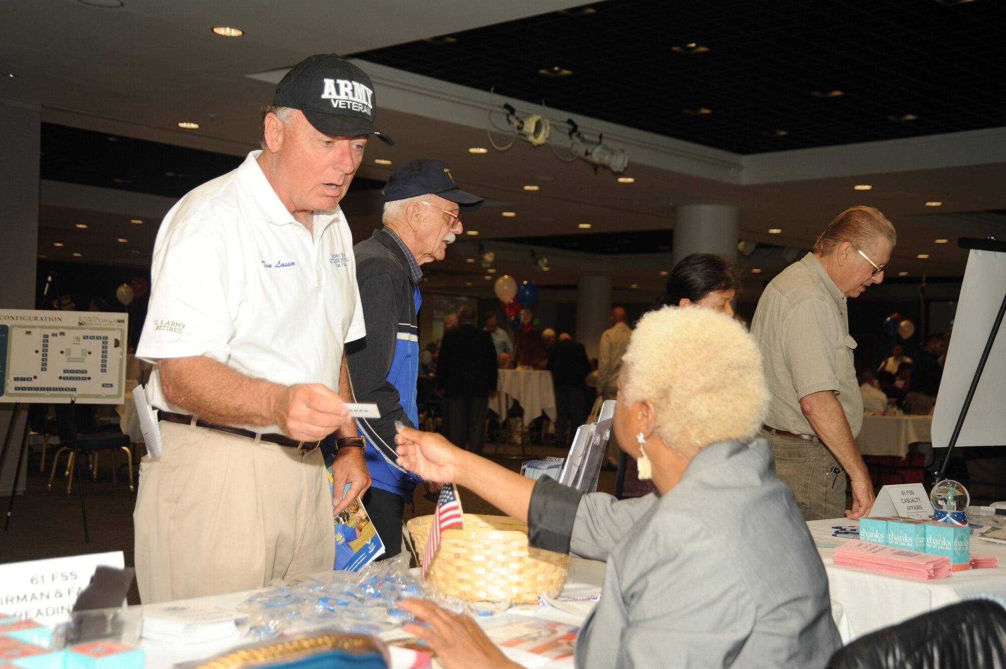 Army retiree Tom Lasser talks to a representative from the Airmen and Family Readiness Center at the annual Retiree Expo, June 26. (Photo by Joe Juarez)