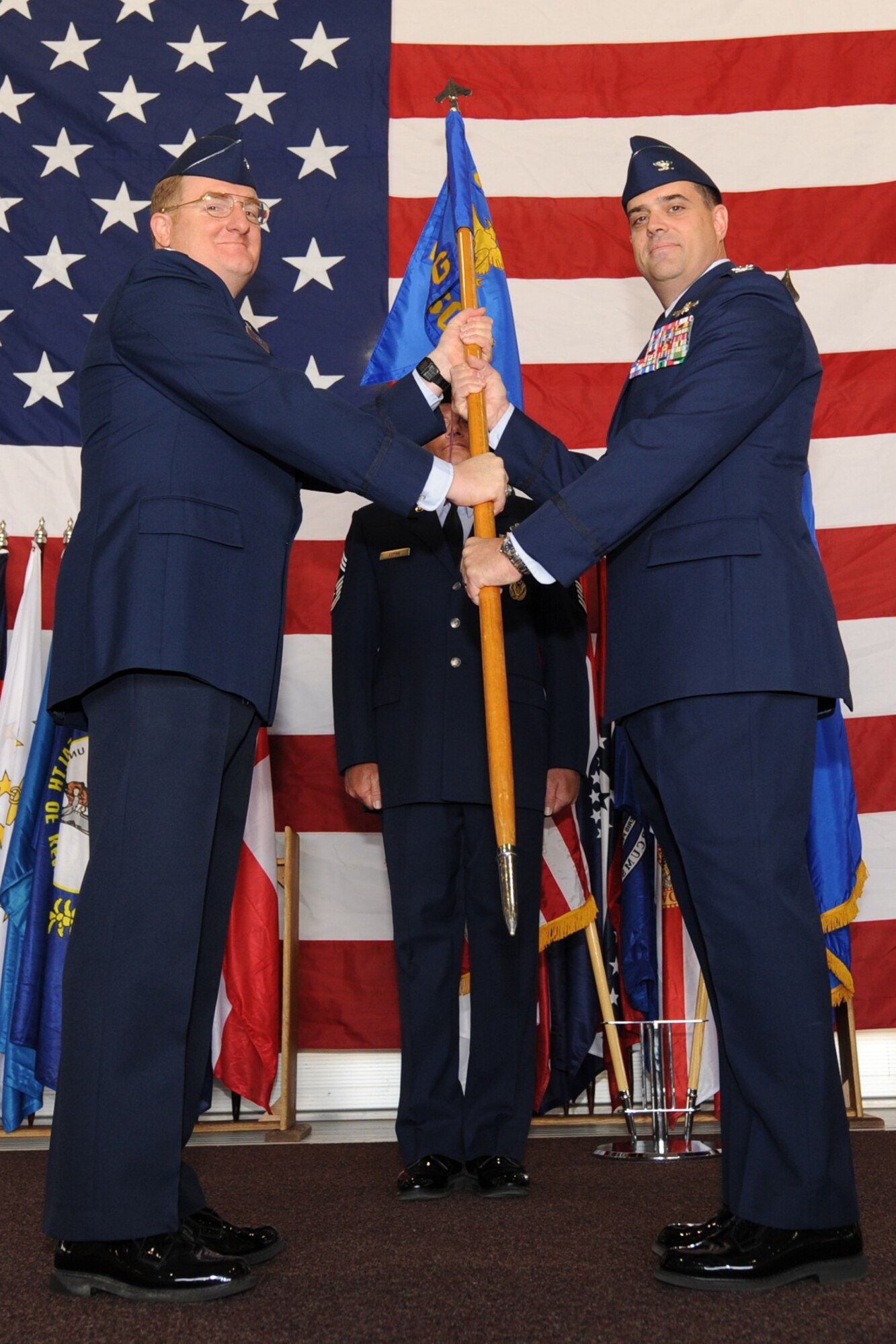 MINOT AIR FORCE BASE, N.D. -- Col. Douglas Cox, 5th Bomb Wing commander, passes the guidon to Col. Michael Dilda, as Colonel Dilda officially assumes command of the 5th Mission Support Group here June 14. (U.S. Air Force Photo by Staff Sgt. Sharida Jackson)