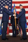 MINOT AIR FORCE BASE, N.D. -- Col. Douglas Cox, 5th Bomb Wing commander, passes the guidon to Col. Michael Dilda, as Colonel Dilda officially assumes command of the 5th Mission Support Group here June 14. (U.S. Air Force Photo by Staff Sgt. Sharida Jackson)