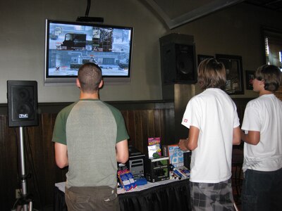 Adam Pollard, left, Derek Cormier, right, and Ian Dahan compete in a "Call of Duty: Modern Warfare 2"  tournament at the Charleston Club on Joint Base Charleston, S.C., June 26, 2010. The charge to compete was $5 and included food and drinks. Prizes such as gift certificates to the base exchange, restaurants and video game console accessories were awarded to the winners of the tournament. (U.S. Air Force photo/Airman 1st Class Haleigh Greer)