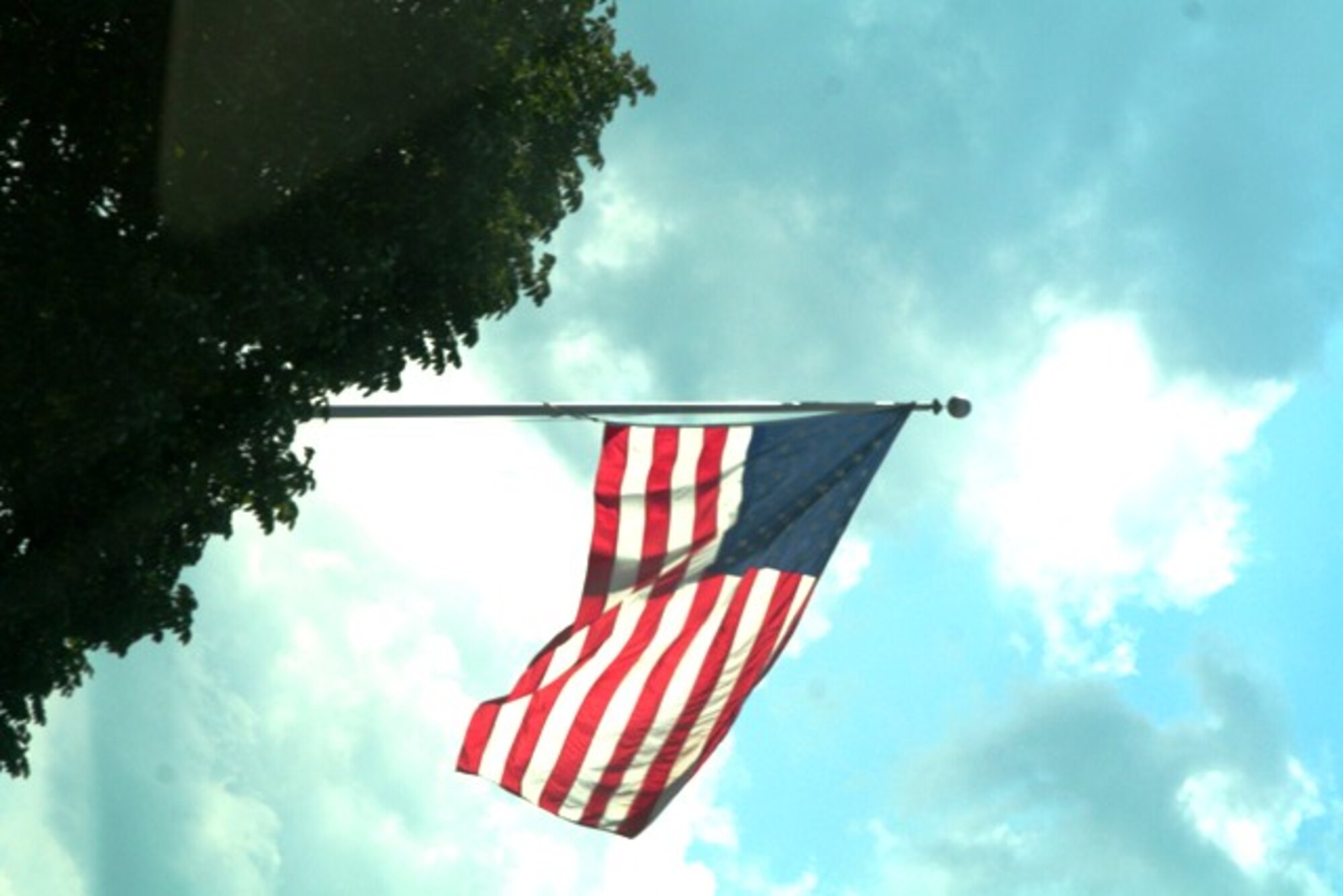 The American flag flies in front of the Air Mobility Command Headquarters at Scott Air Force Base, Ill., June 27, 2010. Air Mobility Command's mission is to provide global air mobility ... right effects, right place, right time. The command also plays a crucial role in providing humanitarian support at home and around the world. AMC Airmen--active duty, Air National Guard, Air Force Reserve and civilians--provide airlift and aerial refueling for all of America's armed forces. (U.S. Air Force Photo/Master Sgt. Scott T. Sturkol) 