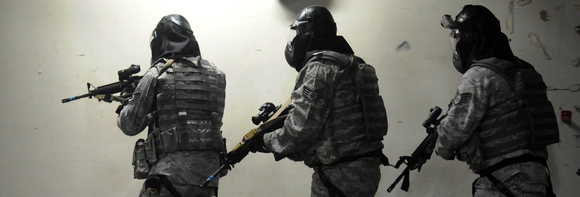 Members of the 354th Security Forces Squadron move with weapons at the ready June 25, 2010, Eielson Air Force Base, Alaska.  Participants of learned how to shoot, move, and communicate during an active shooter scenario.  (U.S. Air Force photo/Airman 1st Class Yash Rojas)