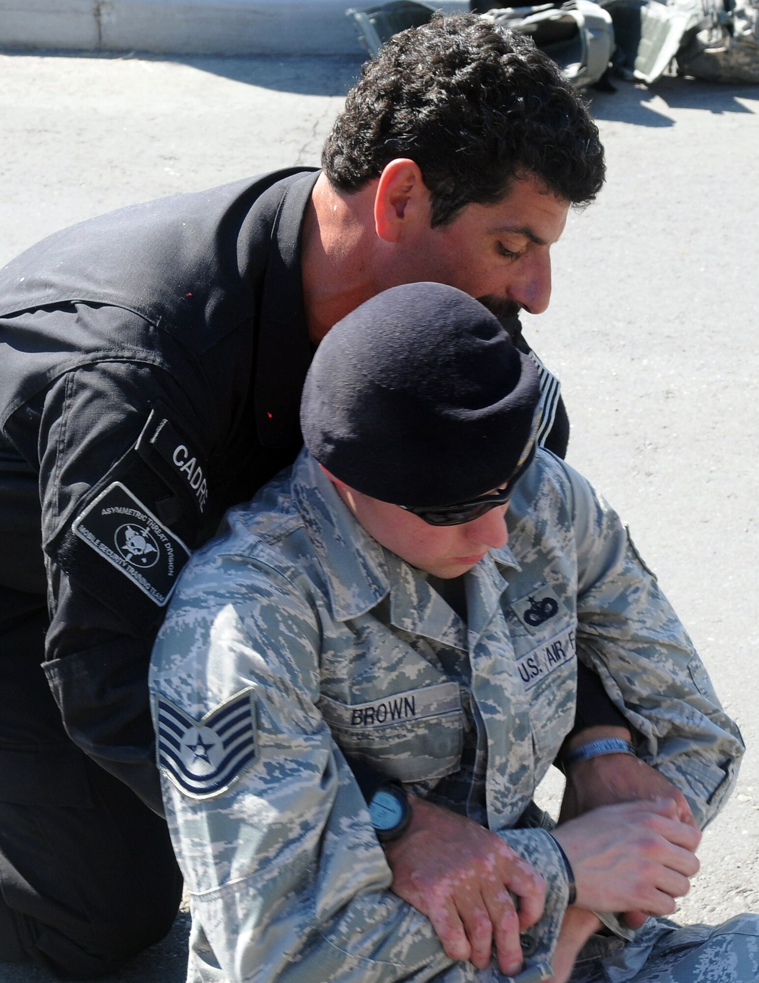 John Knipe uses Tech. Sgt. Robert Brown to demonstrate lifesaving techniques June 25, 2010, Eielson Air Force Base, Alaska. HRRT uses basic tactics, movements and formations as previous active shooter training courses as well as lifesaving techniques in high-risk situations. Mr. Knipe is a mobile training team instructor from Analytical Services Inc., and Sergeant Brown is assigned to the 354th Security Forces Squadron. (U.S. Air Force photo/Airman 1st Class Yash Rojas)