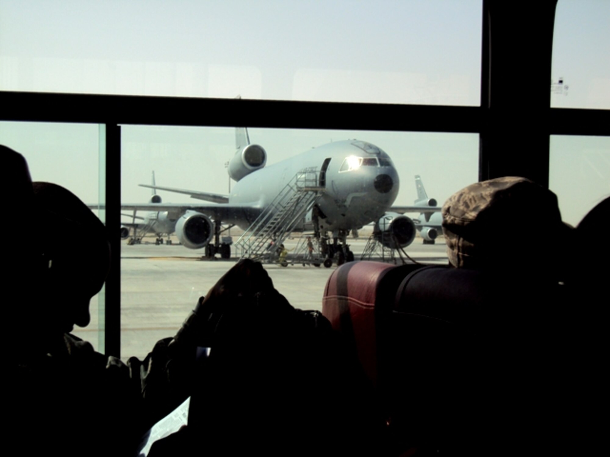 Deployed Airmen ride aboard a bus driven by an aerial porter from the 380th Expeditionary Logistics Readiness Squadron's Air Terminal Operations Center at a non-disclosed base in Southwest Asia on June 24, 2010. Aerial porters, or air transportation Airmen, deployed to the 380th ELRS of the 380th Air Expeditionary Wing are deployed from the 89th Aerial Port Squadron at Joint Base Andrews, Md. (U.S. Air Force Photo/Master Sgt. Scott T. Sturkol)