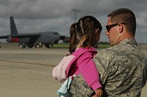 MINOT AIR FORCE BASE, N.D. – Airman Curtis Bish, 5th Aircraft Maintenance Squadron hydraulics apprentice, talks to his daughter, Emily, as a B-52H Stratofortress prepares to take off during a rapid launch exercise here June 28. As a finale to the week-long exercise, family members were invited to watch several B-52s from Minot and Barksdale AFB, La., take off in rapid succession, signaling the end of the training mission. (U.S. Air Force photo by Tech. Sgt. Thomas Dow)