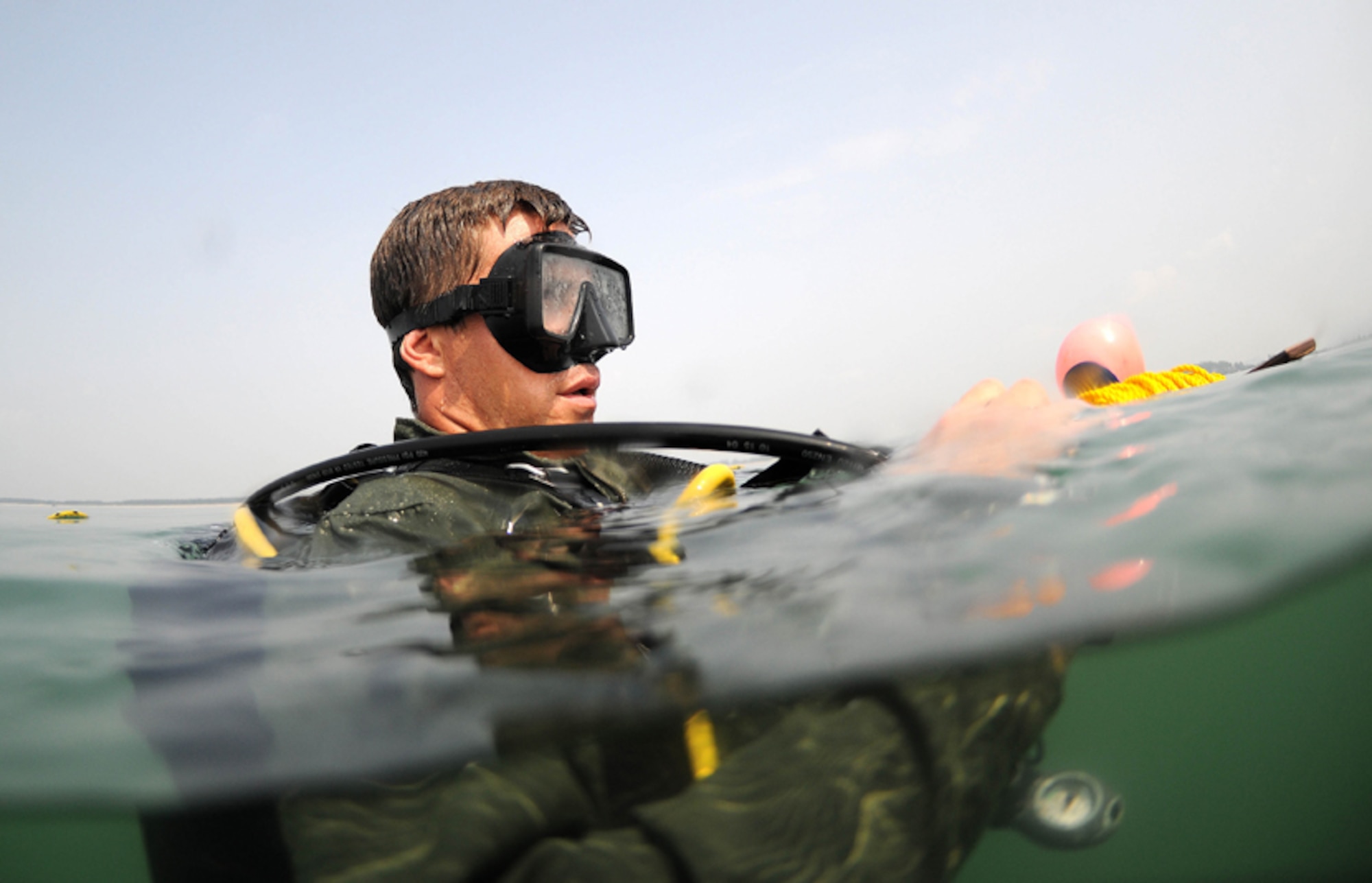 Petty Officer 3rd Class Joshua Westman, a diver with Mobile Diving Salvage Unit 1, secures his dive search line before descending on a scuba dive in support of a Joint POW/MIA Accounting Command recovery mission in the Nghe An province, Socialist Republic of Vietnam. The mission of JPAC is to achieve the fullest possible accounting of all Americans missing as a result of the nation's past conflicts. (JPAC photo by Mass Communication Specialist 1st Class Anderson Bomjardim/Released)