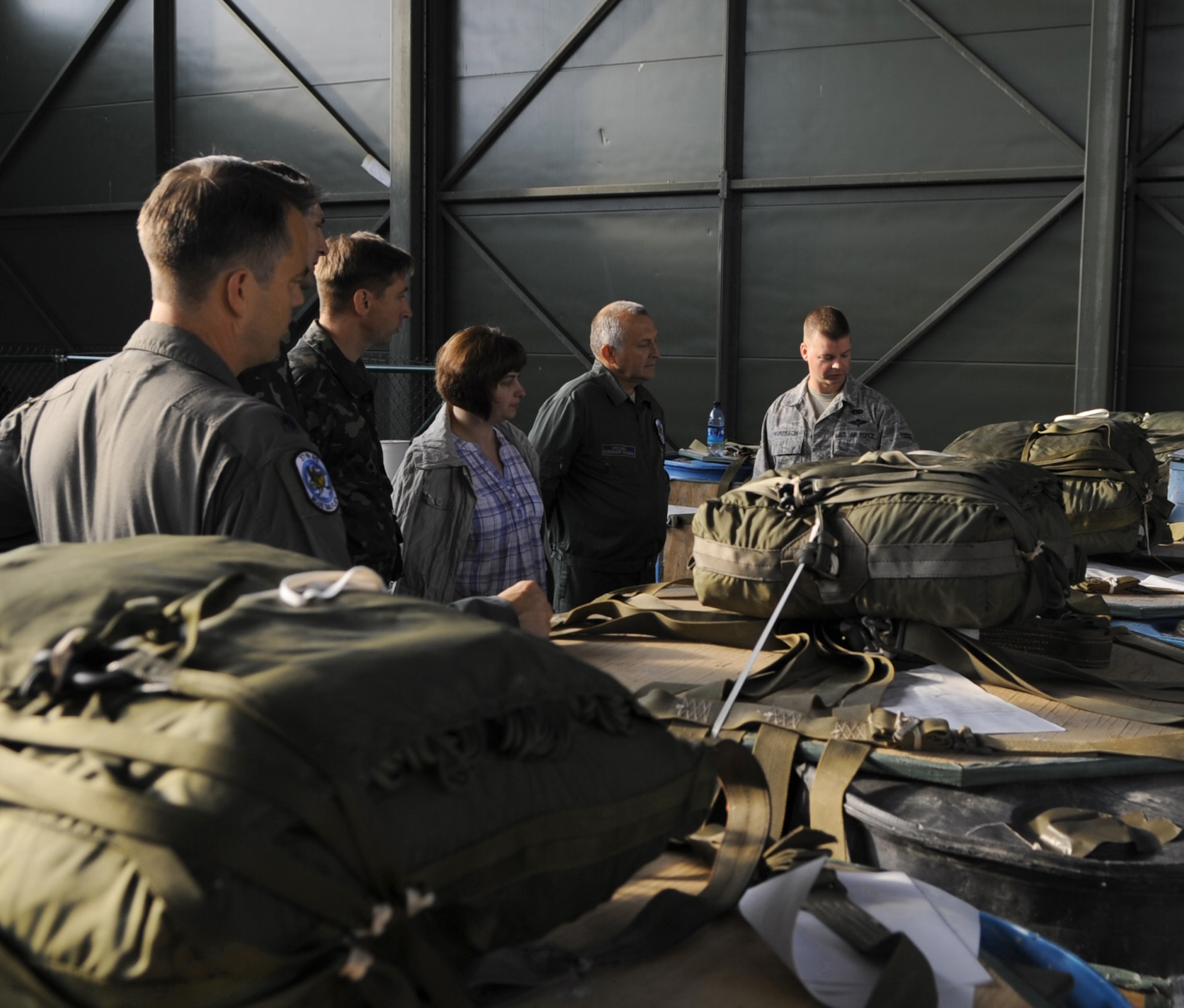 Airman 1st Class Gregory Wurzbach gives a tour of the aerial delivery facility to Ukrainian air force members and an official interpreter June 25, 2010, during a visit to Ramstein Air Base, Germany. The goal of the Ukrainian visit was to help advance military interoperability and build international partnerships. Airman Wurzbach is an 86th Logistics Readiness Squadron aerial delivery Airman. (U.S. Air Force photo/Senior Airman Caleb Pierce)