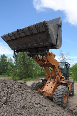 WHITEMAN AIR FORCE BASE, Mo. - Senior Airman Sehldon Mellott, 509th Civil Engineer Squadron heavy equipment operator, uses the clamshell of the front loader to sift out small debris from larger chunks of asphalt and concrete, Monday. Airman Mellott is part of an elite team known as the "Dirtboyz," taking part in multiple payment and concreting jobs around base. After the piles are sorted a contractor will grind up all the materials and recycle for future use on CES projects.(U.S. Air Force photo/ Senior Airman Carlin Leslie)
 