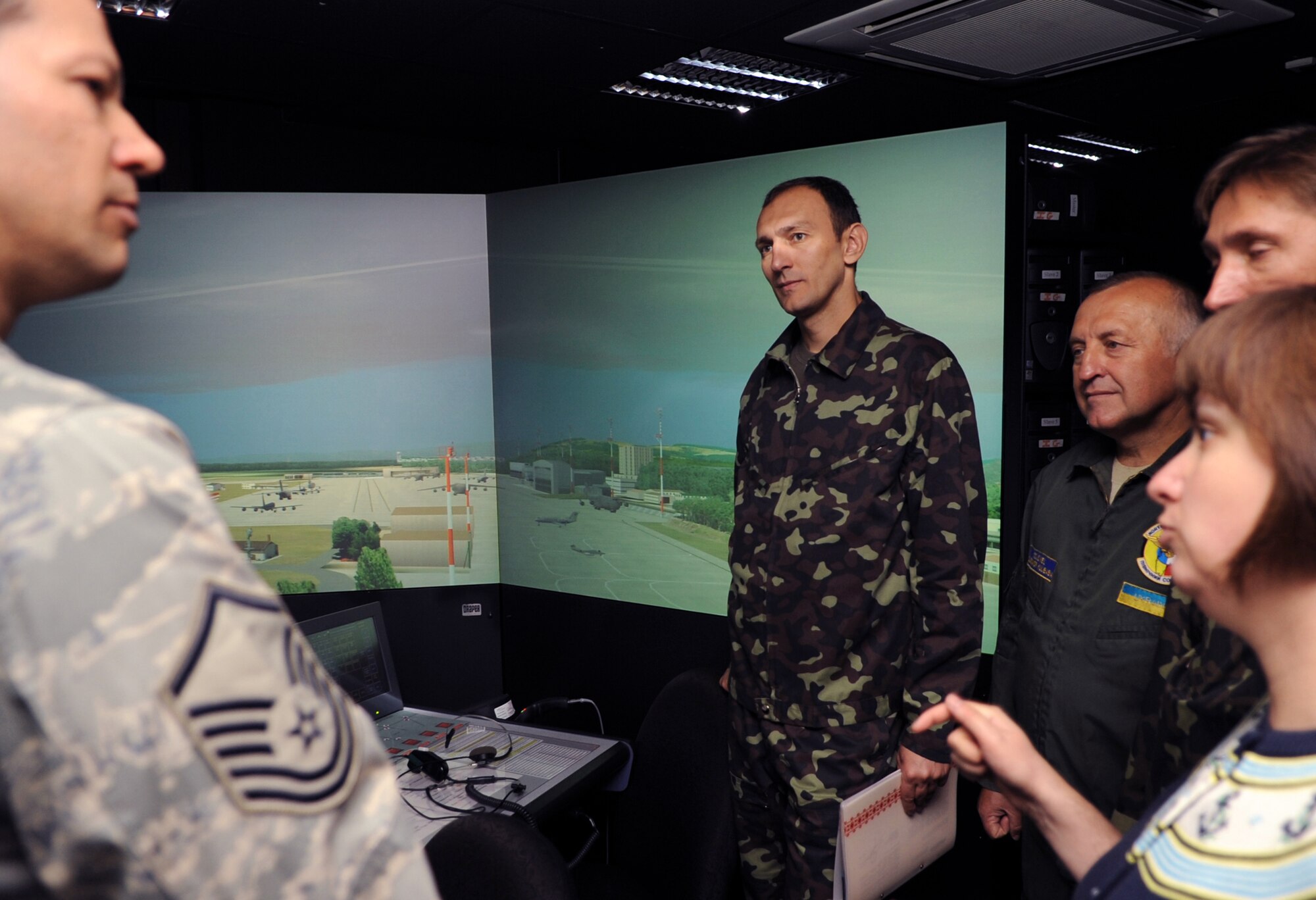 Master Sgt. Roy Wanner gives a tour of the air traffic control training simulation room to Ukrainian air force members June 23, 2010, during a visit to Ramstein Air Base, Germany. The goal of the Ukrainian visit was to help advance military interoperability and build international partnerships. Sergeant Wanner is the 86th Operations Support Squadron air traffic control complex chief controller. (U.S. Air Force photo/Senior Airman Caleb Pierce)