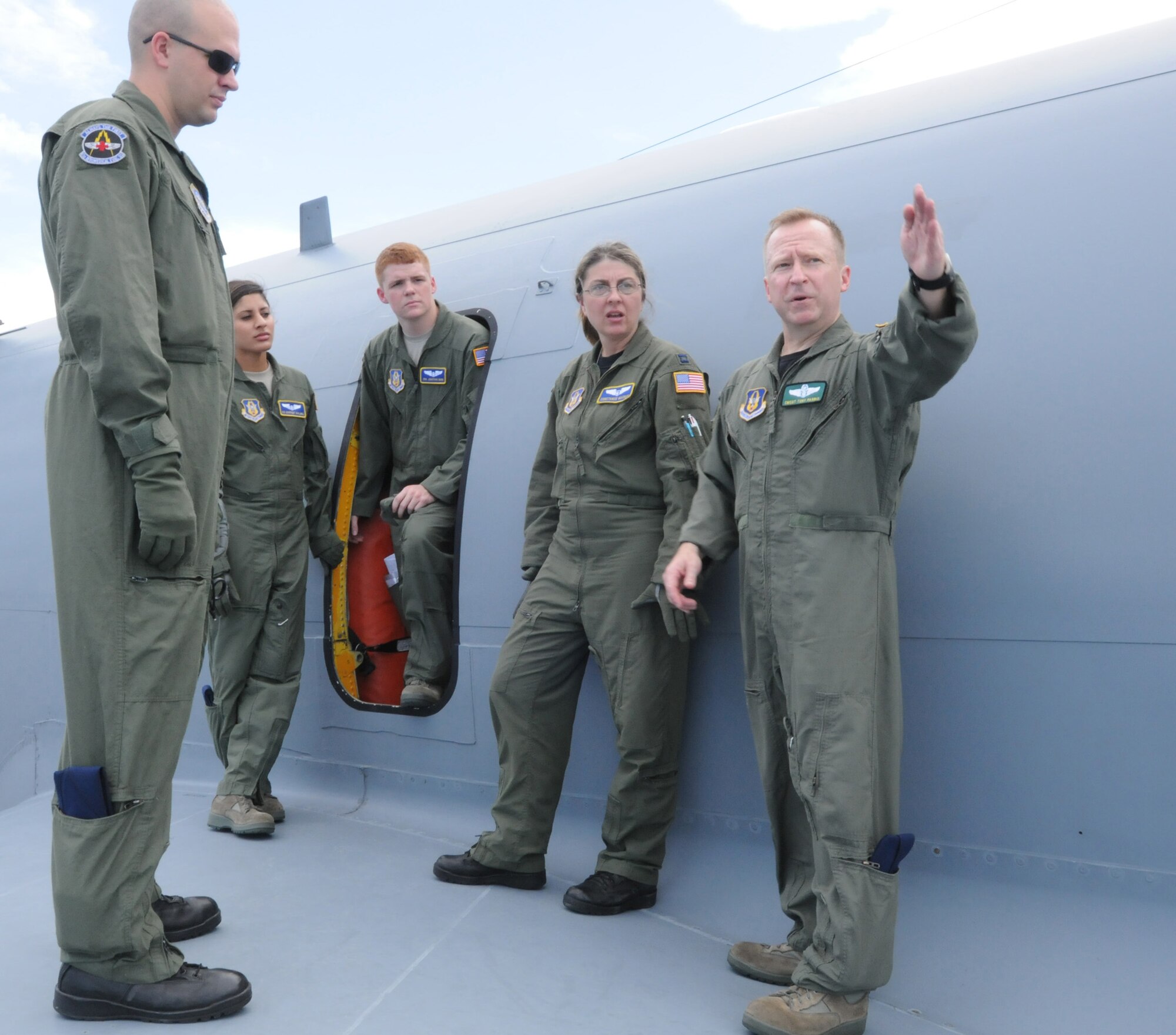 Chief Master Sgt. Tony Parris, 77 Air Refueling Squadron boom operator, shows Airmen from the 36th Aeromedical Evacuation Squadron and the 43rd AES how to safely exit a KC-135R Stratotanker in the event of an emergency landing here June 26. Members from the 459th AES, 36th AES and the 43rd AES participated in a three-day Total Force aeromedical evacuation training mission in Melbourne, Fl. (U.S. Air Force photo/Staff Sgt. Steve Lewis)