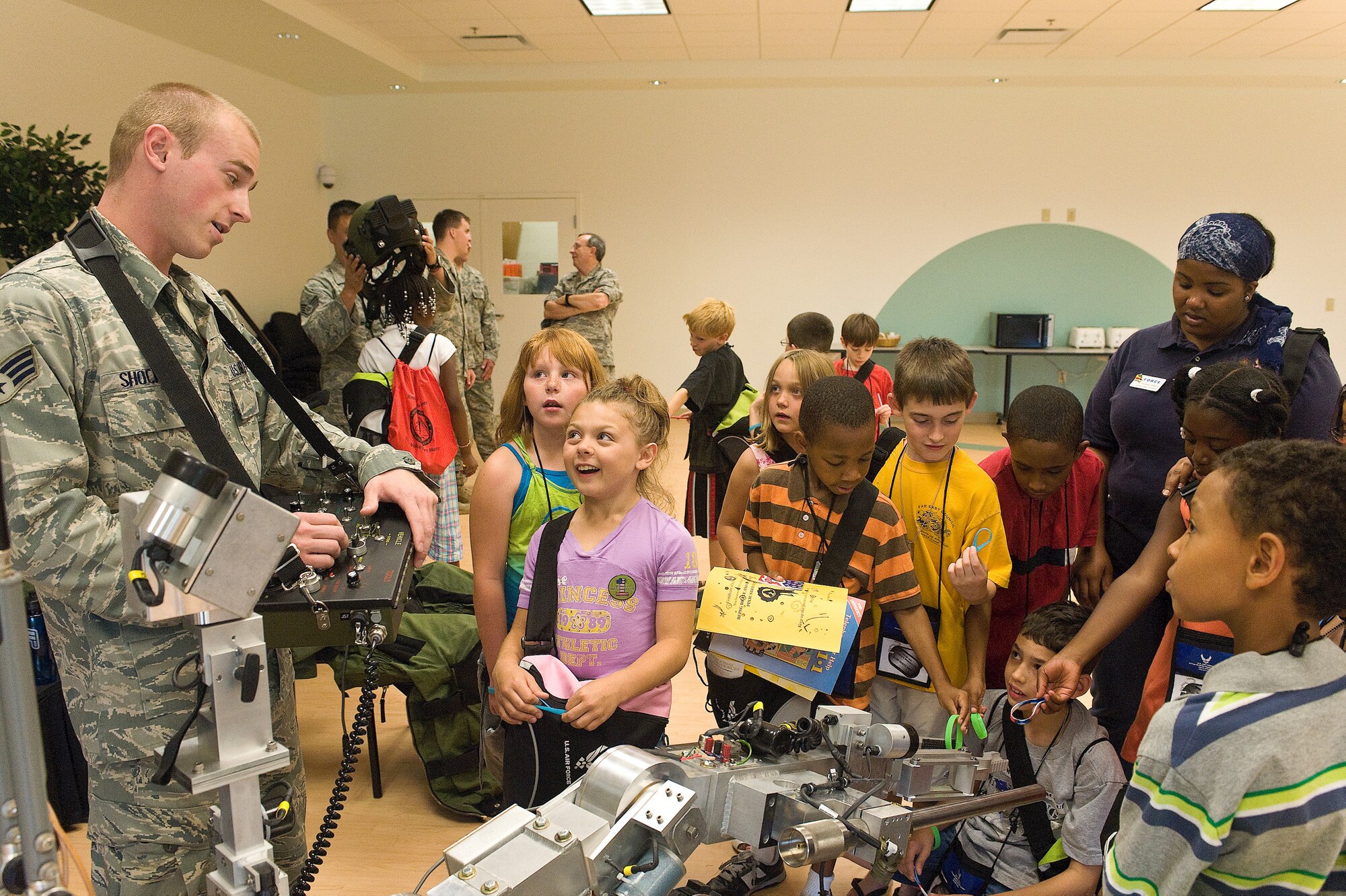 Senior Airman Sheldon Shockley, 436th Civil Engineers Squadron Explosive Ordinance Disposal team, demonstrates the use of an anti-explosive robot during the Children's Mobility Line June 25, 2010. The Children's Mobility Line gave children the opportunity to see the many aspects of deployment. (U.S. Air Force photo by Roland Balik/Released)