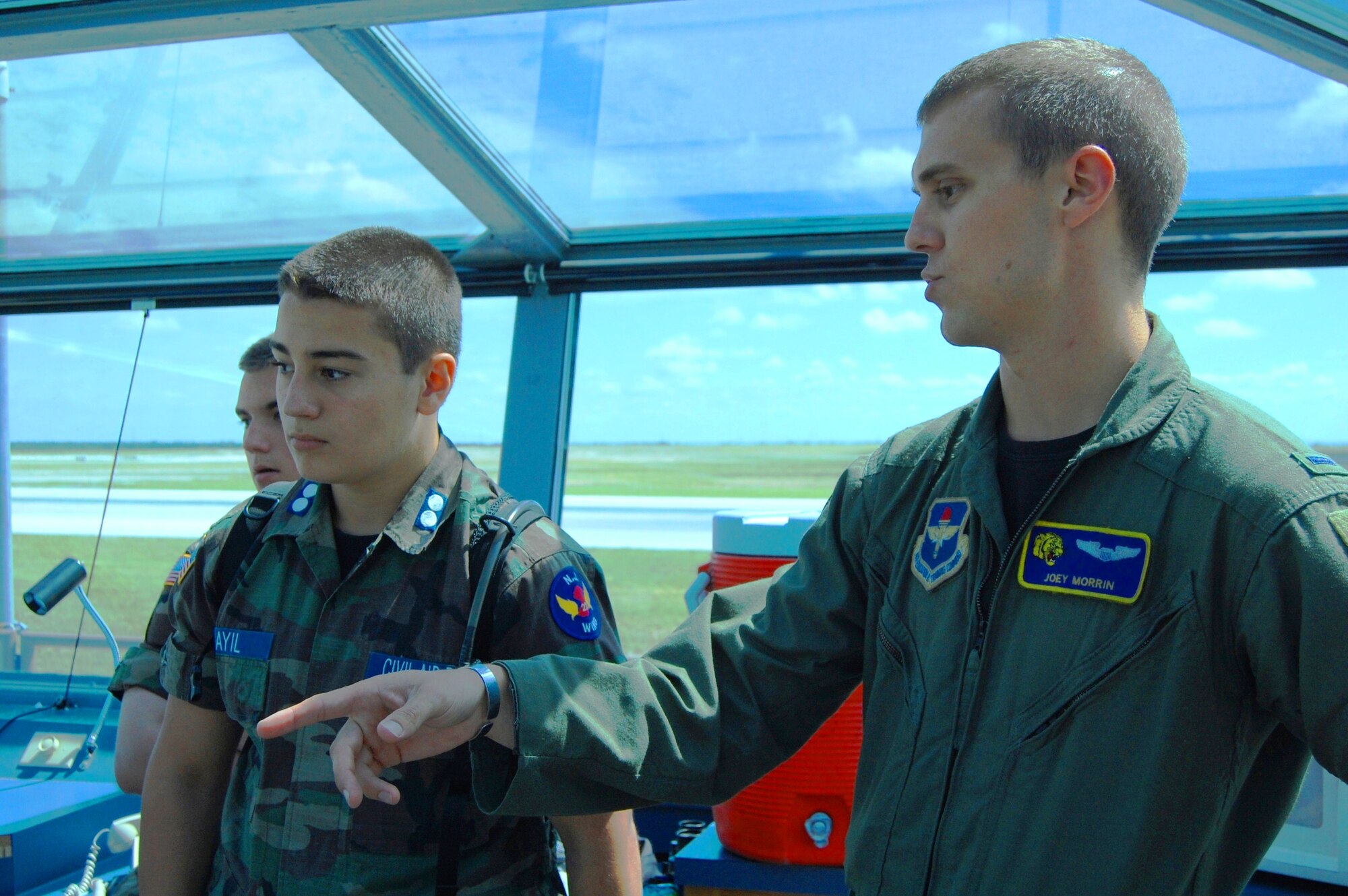 LAUGHLIN AIR FORCE BASE, Texas – First Lt. Joey Morrin, scheduler in the 85th Flying Training Squadron, explains what various instruments in a runway supervisory unit do to Cadet Alan Sayil, of East Hanover, N.J. (front), and Cadet Tim McClure, of Linden, Wash. (back). The Civil Air Patrol cadets participated June 18 through 26 in the Specialized Undergraduate Pilot Training Familiarization Course. The cadets traveled from across the nation to learn about the training Air Force pilots must complete before they are qualified to fly. (U.S. photo by Staff Sgt. Desiree Economides)