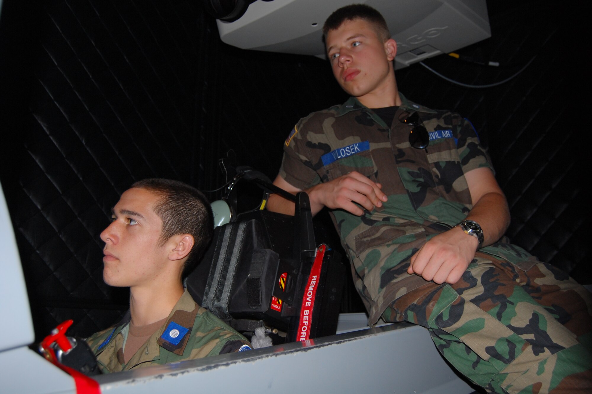 LAUGHLIN AIR FORCE BASE, Texas – Cadet Bobby Wlosek, Chicago Civil Air Patrol, observes while cadet Ryan Cole, Clarke County Composite Squadron in Athens, Ga., flies a T-6 simulator here June 24. The Civil Air Patrol cadets participated June 18 through 26 in the Specialized Undergraduate Pilot Training Familiarization Course. The cadets traveled from across the nation to learn about the training Air Force pilots must complete before they are qualified to fly. (U.S. Air Force photo by Staff Sgt. Desiree Economides) 