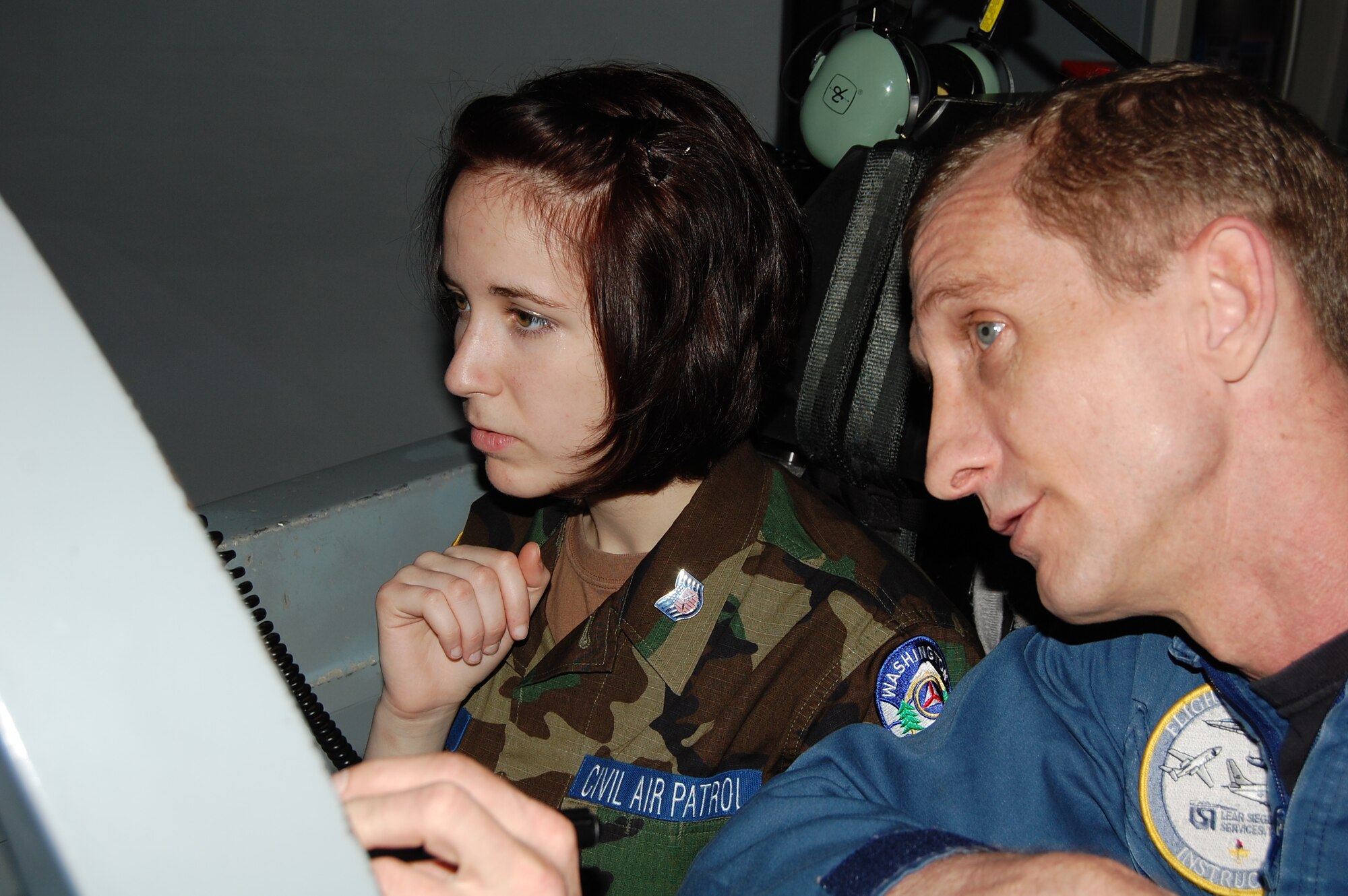 LAUGHLIN AIR FORCE BASE, Texas – Cadet Langdon Wright, Arlington Composite Squadron, Wash., focuses intently while William Turner, 47th Operations Group simulator instructor, points out mechanical detail in a T-6 simulator here June 24. Cadet Wright and 30 other Civil Air Patrol cadets participated June 18 through 26 in the Specialized Undergraduate Pilot Training Familiarization Course. The cadets traveled from across the nation to learn about the training Air Force pilots must complete before they are qualified to fly. (U.S. Air Force photo by Staff Sgt. Desiree Economides)