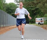 Maj. Shannon Mann, 916th Public Affairs Officer, completes the wing warrior run in May. In this commentary she offers insight for preparing for the new Fit to Fight standards. (USAF photo by TSgt. Scotty Sweatt, 916ARW/PA)