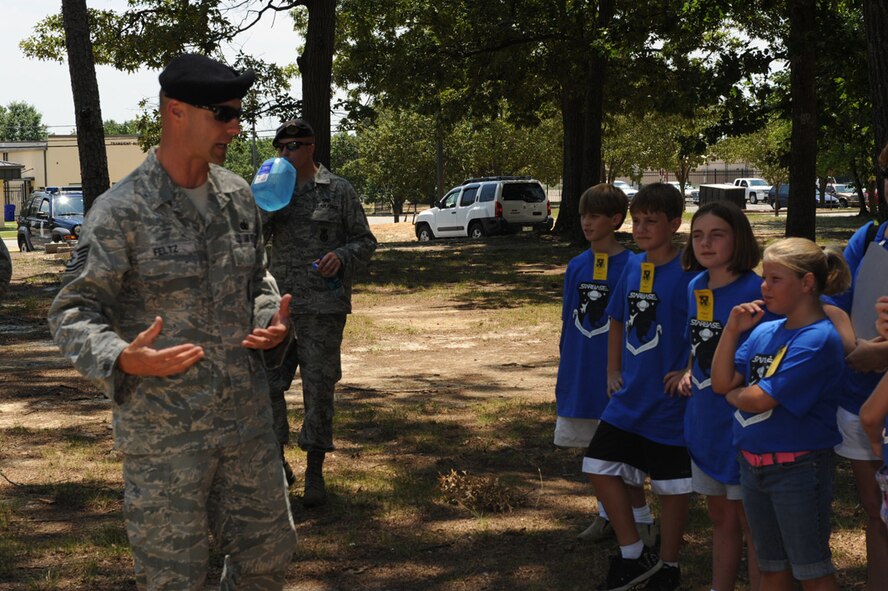 SEYMOUR JOHNSON AIR FORCE BASE, N.C. -- Tech. Sgt. Ryan Feltz explains to a group of Science and Technology Academies Reinforcing Basic Aviation and Space Exploration students the dog handler duties and responsibilities here June 21, 2010. STARBASE is an annual week-long open to fifth graders. Sergeant Feltz is a 4th Security Forces Squadron dog handler and hails from Coldwater, Ohio. (U.S. Air Force photo/Senior Airman Gino Reyes)