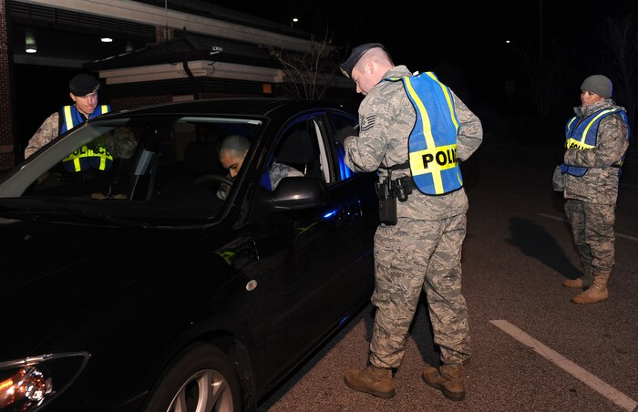 Patrolmen with the 628th Security Forces Squadron conduct a mandatory sobriety checkpoint screening at the Dorchester Road main gate at Joint Base Charleston, S.C., in the early morning Jan. 10, 2010. The checkpoint was conducted as part of the commander directed Operation Sober Roads 2. During the Fourth of July weekend, the 628 SFS will join a community-wide effort to deter, educate and enforce driving laws by conducting random sobriety checkpoints in multiple locations on base. (U.S. Air Force photo/Senior Airman Katie Gieratz)
