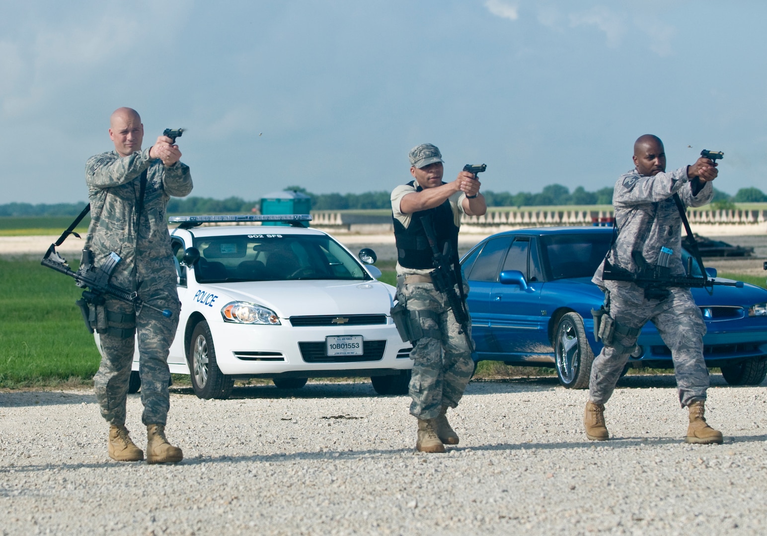 Tech. Sgt. Scott Schlasser, Staff Sgt. Teron Mobley , and MSgt. Joseph Thompson practice transitioning from one weapon to another and continuous fire at evalulator's training June 25 at Randolph Air Force Base, Texas.  (U.S. Air Force photo by Steve White)