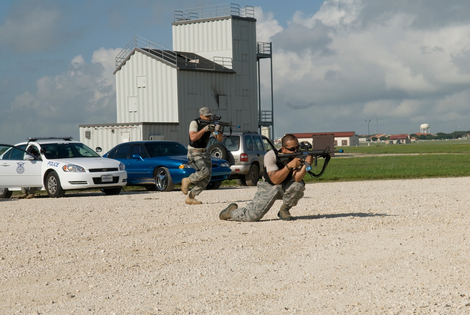 Staff Sgt. Jeffren Reyes and Sgt. Teron Mobley, 902 SFS Training, show proper technique of fire and cover advancing during a training class for evalulator training June 25 at Randolph Air Force Base, Texas.  (U.S. Air Force photo by Steve White)