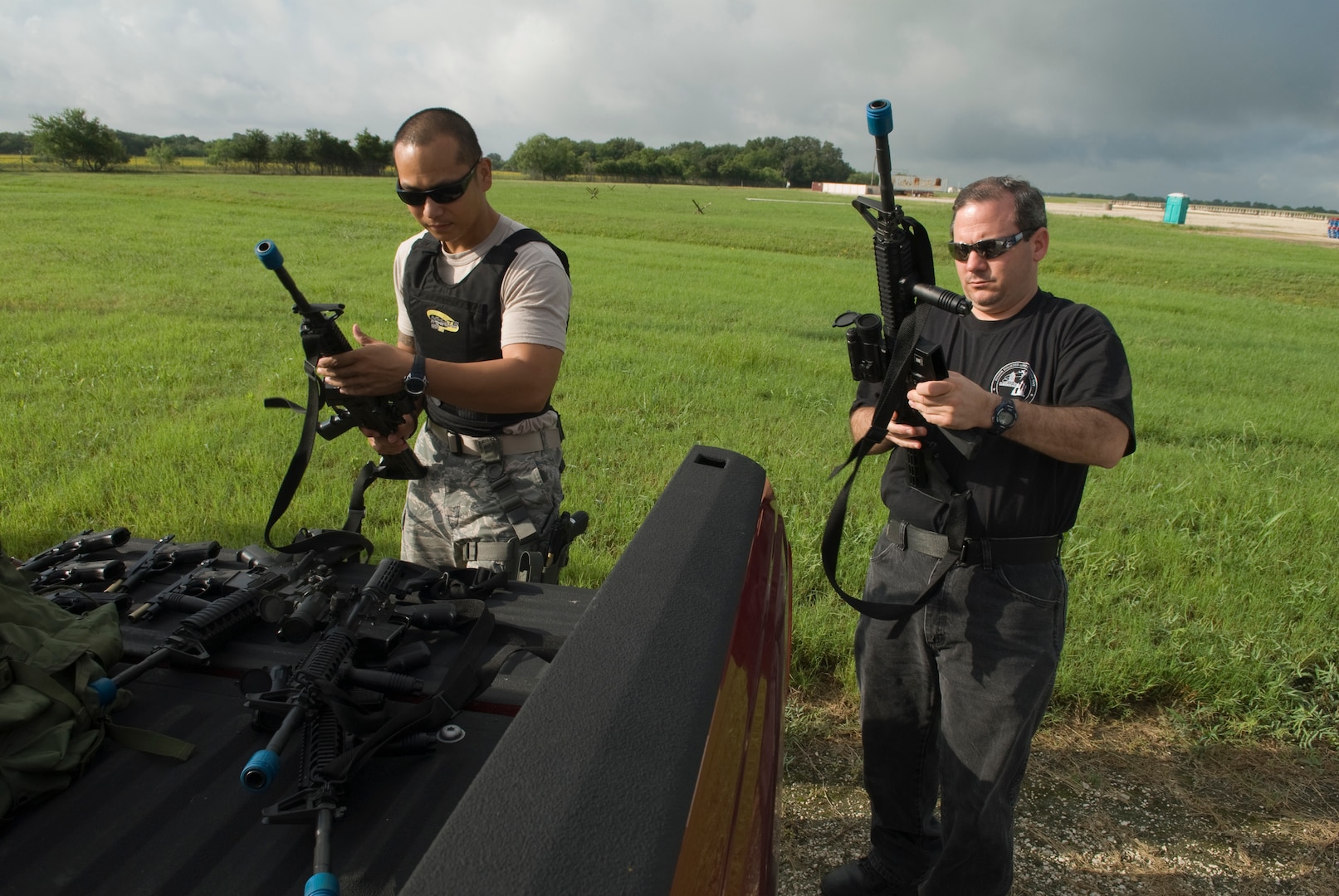 Staff Sgt. Jeffren Reyes and Joseph Del Forte, 902 ABW Security Forces, inspect weapons before issuing for a training class June 25 at Randolph Air Force Base, TX.  (U.S. Air Force photo by Steve White)