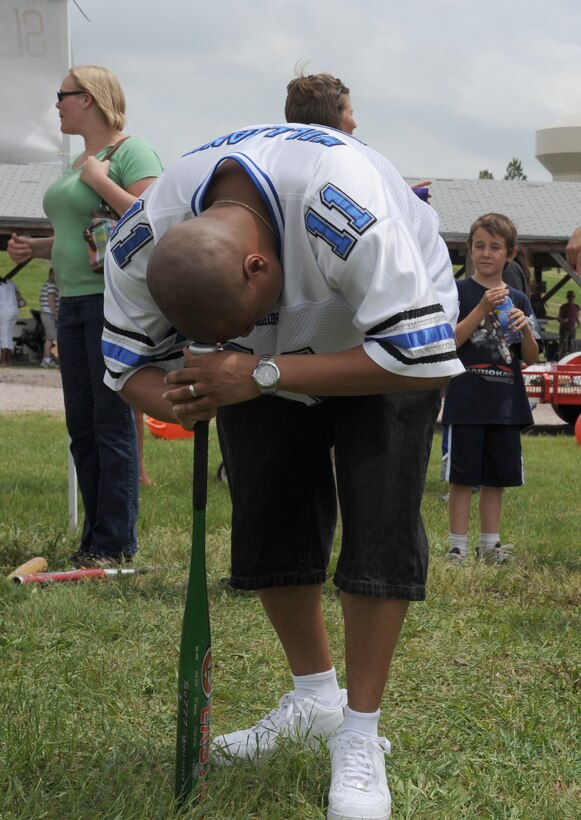 ELLSWORTH AIR FORCE BASE, S.D.-- Tech. Sgt Ruben Hollins, 28 Communications Squadron Cyber-transport Systems NCOIC spins on a baseball bat during the Party at the Lake slackerthon here June 26. The slackerthon events included marshmallow eating, soda chugging and paintball.   (U.S. Air Force photo/Master Sgt. Loren J. Bonser)

