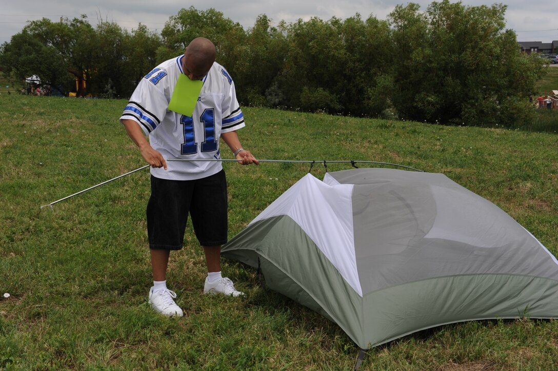 ELLSWORTH AIR FORCE BASE, S.D.-- 
Tech. Sgt Ruben Hollins, 28 Communications Squadron cyber-transport systems NCO in-charge constructs a tent during the Party at the Lake slackerthon, June 26. The winner of the slackerthon received a recliner with a built-in cooler.   (U.S. Air Force photo/Master Sgt. Loren J. Bonser)

