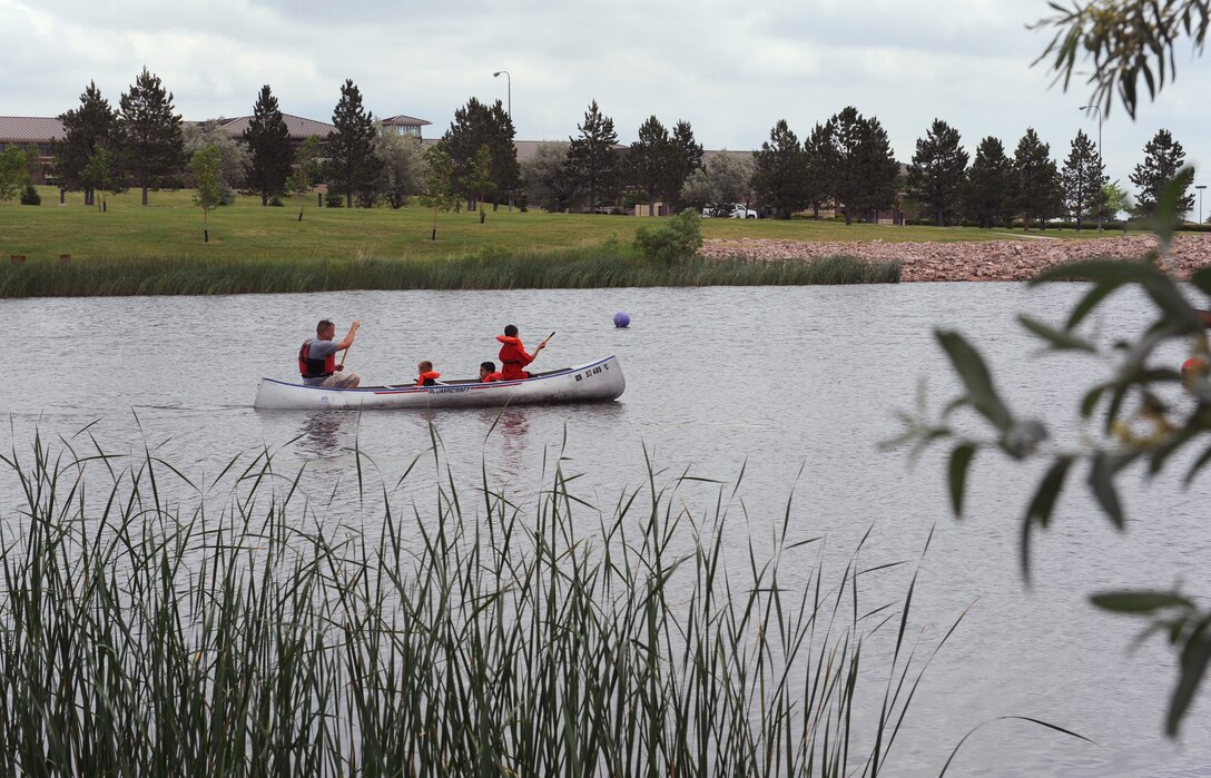 ELLSWORTH AIR FORCE BASE, S.D.-- Participants in the canoe race prepare to turn their canoe around and head to the finish line during the Party at the Lake, June 26. This annual event hosted by the Airman and Family Readiness Center and Outdoor Recreation was part of the bases' Year of the Air Force Family initiative held throughout the year. (U.S. Air Force photo/Master Sgt. Loren J. Bonser)

