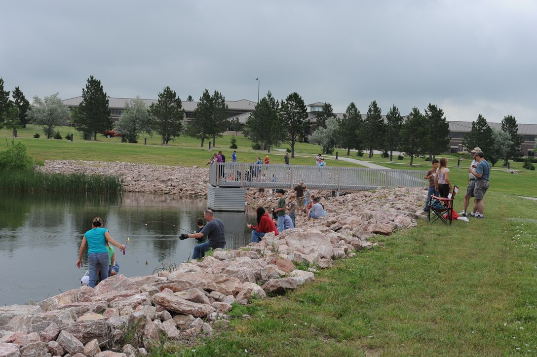 ELLSWORTH AIR FORCE BASE, S.D.-- Participants of the fishing derby cast out their lines during the Party at the Lake June 26. This annual event, hosted by the Airman and Family Readiness Center and Outdoor Recreation, included canoe races, geocaching and a slackerthon where participants competed for a recliner as the grand prize. (U.S. Air Force photo/Master Sgt. Loren J. Bonser)

