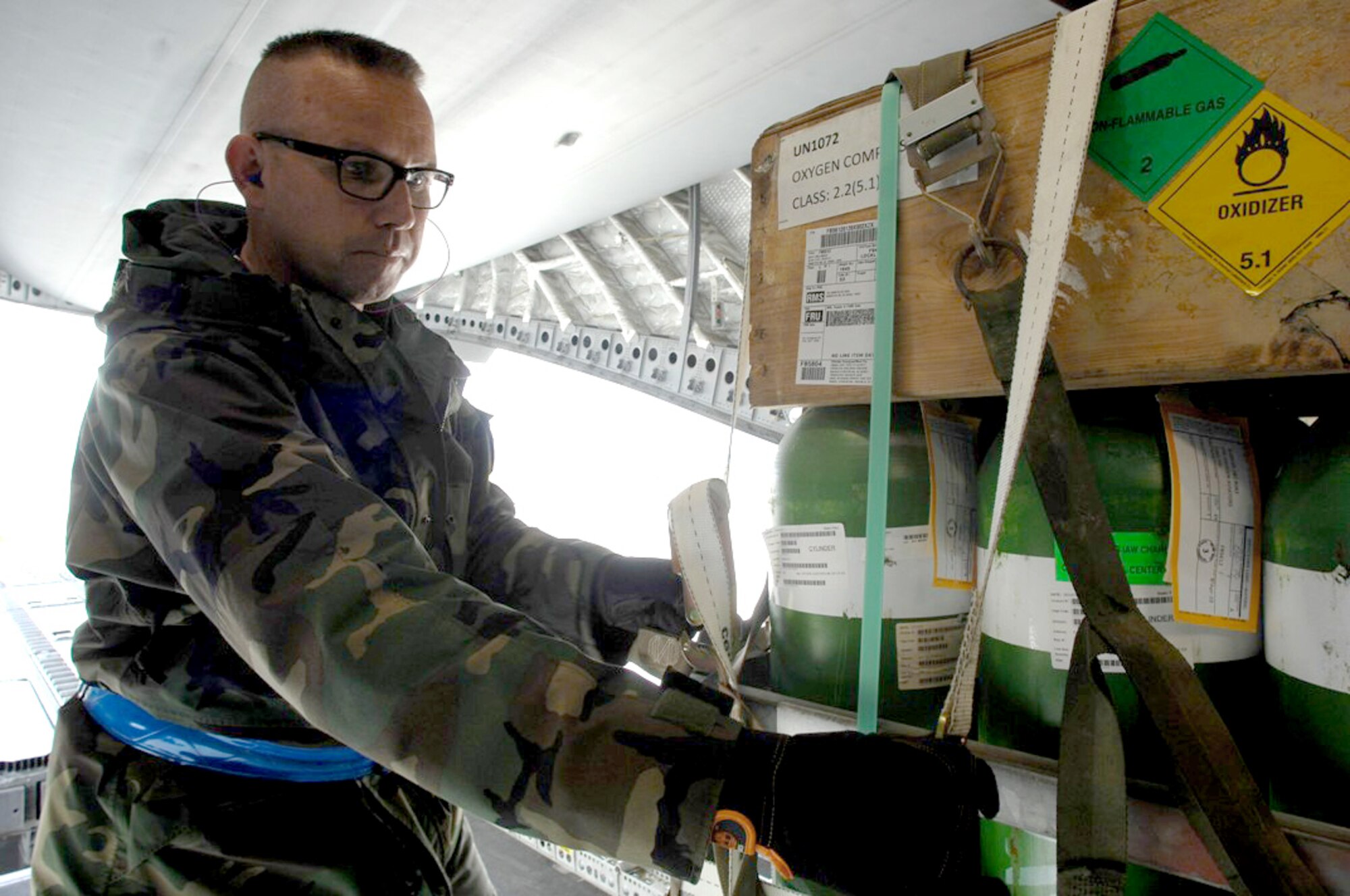 Kasper Chevalier secures cargo after being loaded into a C-17, Globemaster III June 23, 2010 at Ramstein Air Base, Germany. Mr. Chevalier is an aerial porter in the 721st Aerial Port Squadron. (U.S. Air Force photo/Tech. Sgt. Michael Voss)