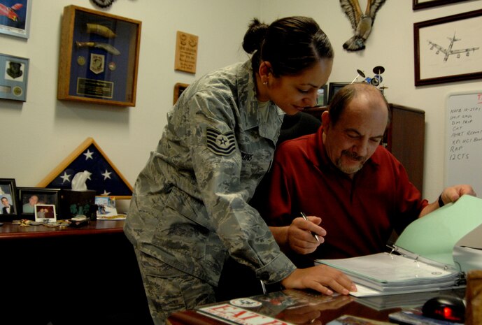Tech Sgt. Jasmine Jenkins and Mr. Ernie Giovannoni of the 99th air base wing plans and programs office look through lists of unit requirements as they begin preparations for the 2011 UCI. Although the actual UCI will occur over a year from now, all units should begin their self-assessments now to make sure all requirements and objectives are met.