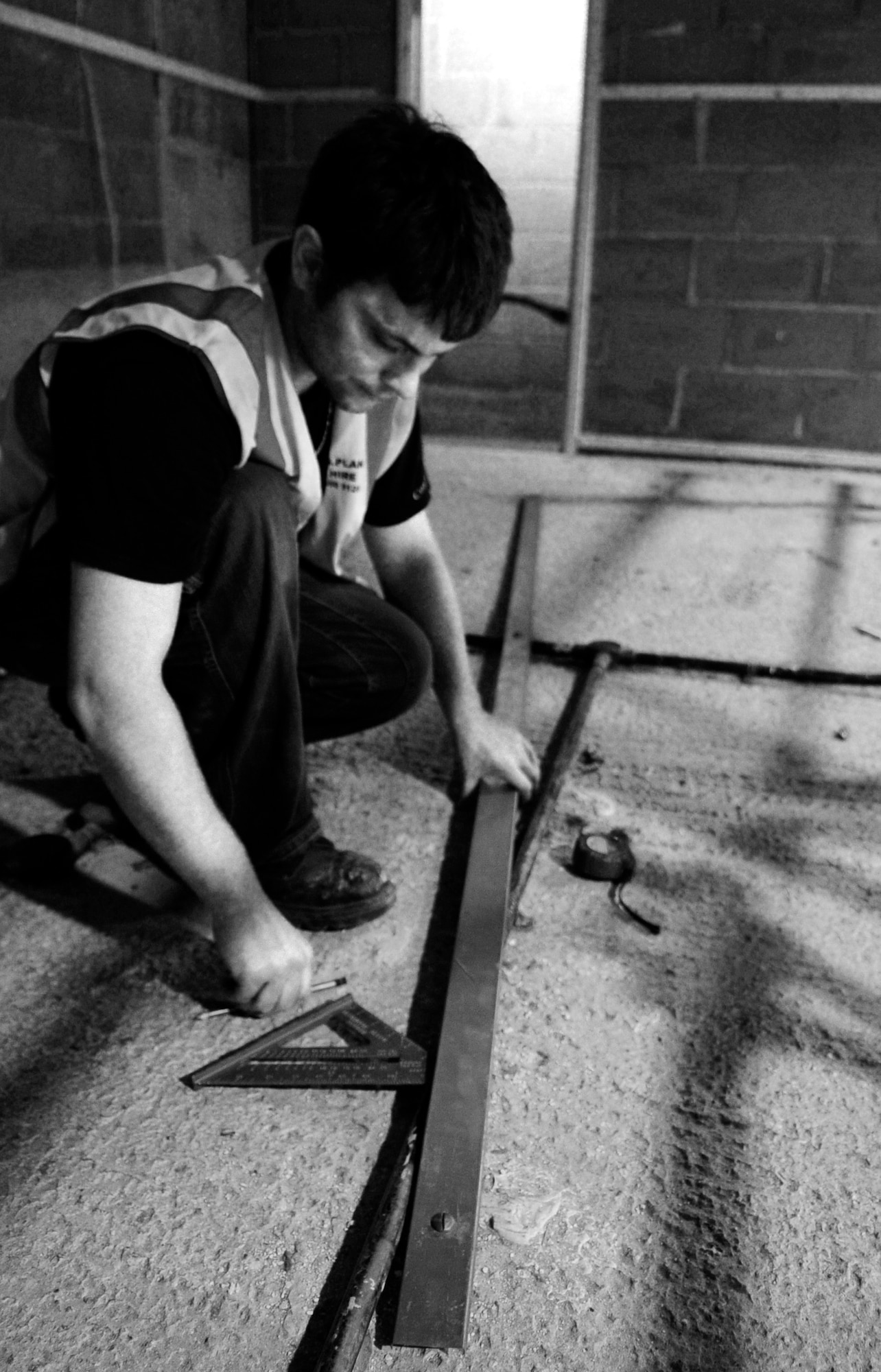 RAF MILDENHALL, England – Stewart Beckford, a local contractor, measures components for the sound-deadening wall panels at the Base Theater June 29. The renovation is scheduled to continue through July.  (U.S. Air Force photo/Staff Sgt. Christopher L. Ingersoll)
