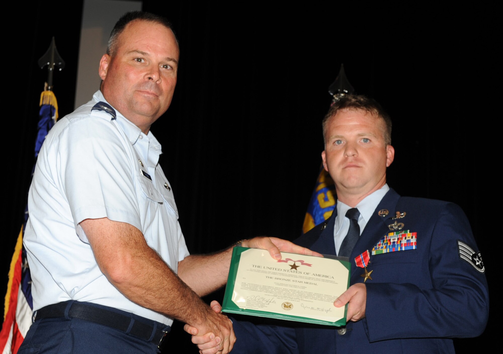 SEYMOUR JOHNSON AIR FORCE BASE, N.C. -- Staff Sgt. Matthew Cooper receives a Bronze Star Medal from Col. William Thomas here June 28, 2010. Sergeant Cooper earned the medal for his actions in a combat zone while supporting Operation Enduring Freedom at forward operating base Altimur. Sergeant Cooper, 4th Civil Engineer Squadron explosive ordnance disposal technician, hails from Knoxville, Tenn. Colonel Thomas is the 4th Mission Support Group commander. (U.S. Air Force photo/Senior Airman Gino Reyes) 