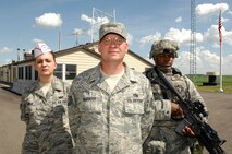 NEAR RYDER, N.D. – Tech. Sgt. Guy Ulshafer (center), 740th Missile Squadron Echo-01 facility manager site senior, Airman 1st Class Megan Cinelli (left), 740th MS missile alert facility chef, and Airman 1st Class Charles Folks (right), 91st Missile Security Forces Squadron security response team member, pose for a photo outside of MAF E-01 here June 24. The professionalism of these 740th MS Airmen played an integral part in the MAF winning the Maj. Gen. M. C. “Tim” Padden Award for best Missile Alert Facilities in Air Force Space Command for 2009. (U.S. Air Force photo by Tech. Sgt. Thomas Dow)
