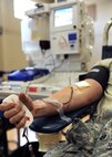 U.S. Air Force Tech. Sgt. Lester Crim squeezes a stress pad to build up pressure, allowing for easier collection through the ALYX Component Collection System at the Sports and Fitness Center June 23, 2010, at Joint Base Charleston, S.C. The Red Cross is targeting donors with O-type blood for the new device because the blood is universal and the most used blood at hospitals. Also being targeted is A negative and B negative blood. The ALYX donation takes 10 to 15 minutes longer than a conventional donation, but is otherwise no different to the donor. After the ALYX donation, the donor is advised not to donate again for 112 days due to the long period the red blood cells take to regenerate. Sergeant Crim is a jet engine mechanic with the 315th Maintenance Squadron. (U.S. Air Force photo/Senior Airman Timothy Taylor)