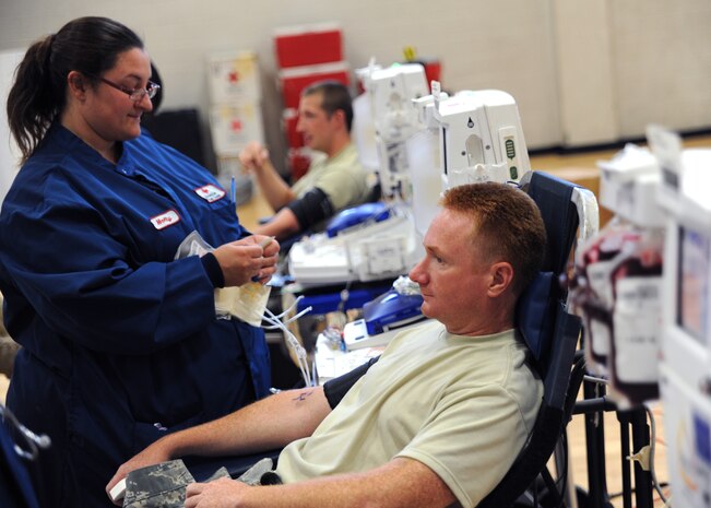 U.S. Air Force Tech. Sgt. Lester Crim sits among other ALYX doners waiting for Red Cross technicians to prepare them before donation at the Red Cross mobile blood drive at the Sports and Fitness Center June 23, 2010, at Joint Base Charleston, S.C. The ALYX donation uses the ALYX Component Collection System to collect two pints of red blood cells in one sitting. The ALYX system uses a centrifuge to separate the red blood cells from the plasma and platelets. After seperating  blood cells, the machine returns plasma and platelets with some added saline solution. Sergeant Crim is a jet engine mechanic with the 315th Maintenance Squadron. (U.S. Air Force photo/Senior Airman Timothy Taylor)