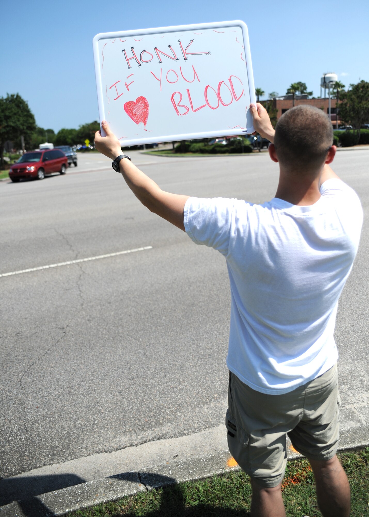U.S. Air Force Capt. Andrew Havko advertises for the American Red Cross volunteer blood drive outside the Sports and Fitness Center June 23, 2010, at Joint Base Charleston, S.C. Captain Havko assisted with organizing the blood drive and is the ramp services flight commander for the 437th Aerial Port Squadron. (U.S. Air Force photo/Senior Airman Timothy Taylor)